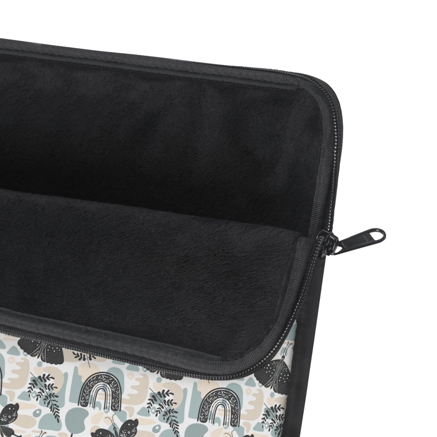 A cute boho chic style laptop sleeve with rainbows, plant leaves, and butterflies design. The padded fleece inside and black zipper can also be seen in this picture.