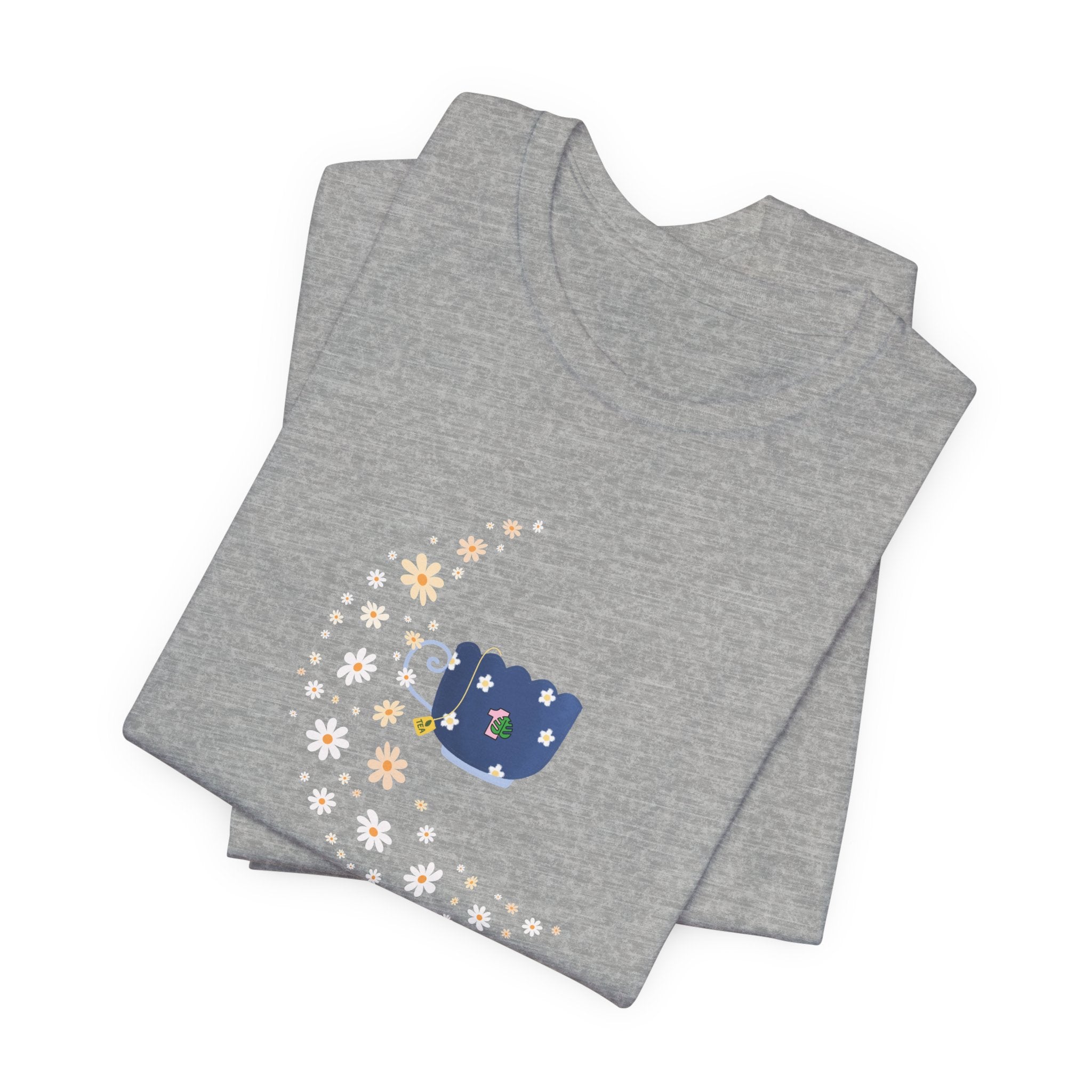 A tee-shirt featuring a floral moon and a teacup design.  It has a crew neck and short sleeves.