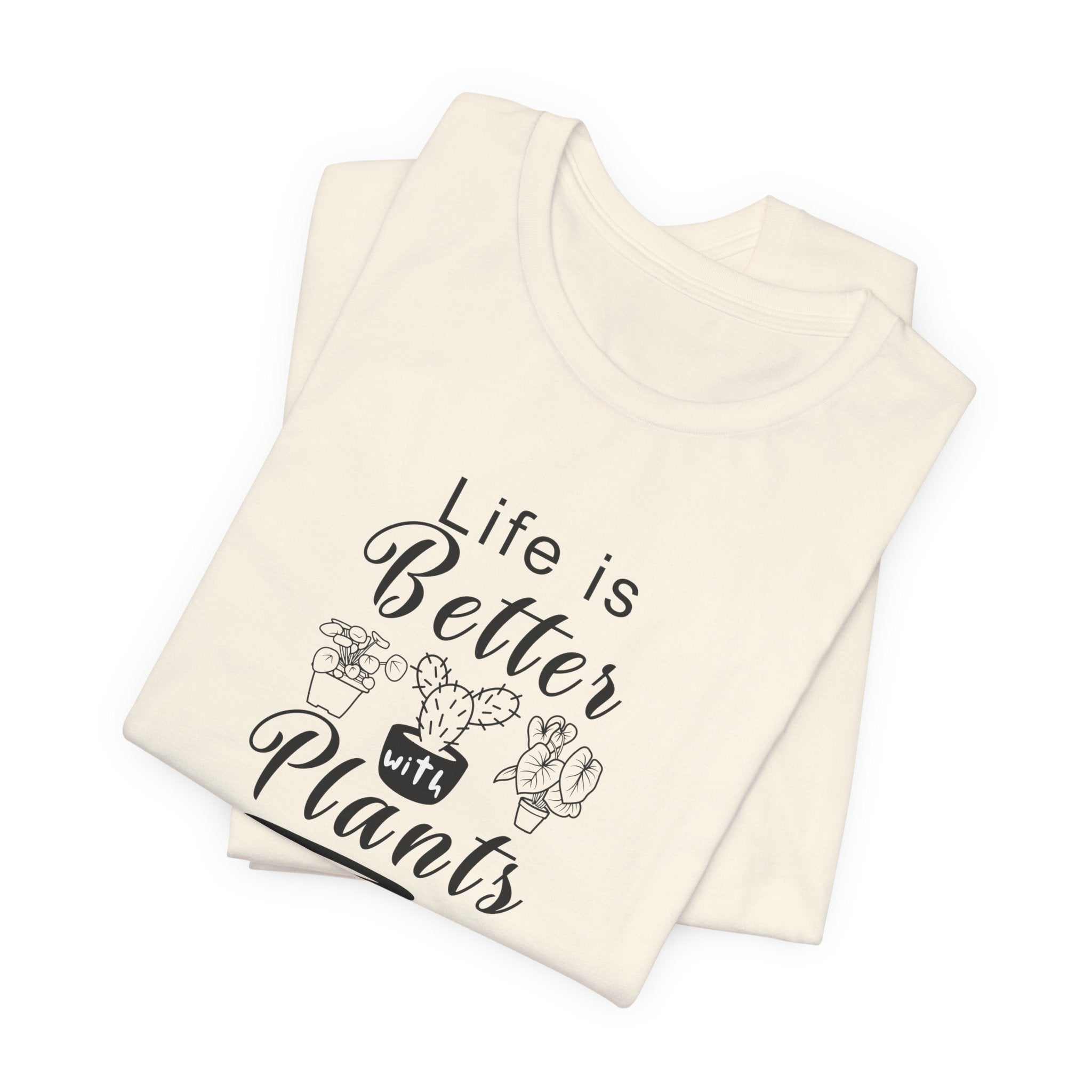A folded t-shirt with the text "Life is Better with Plants" printed on the front. The shirt comes in a natural color and the text comes in black.