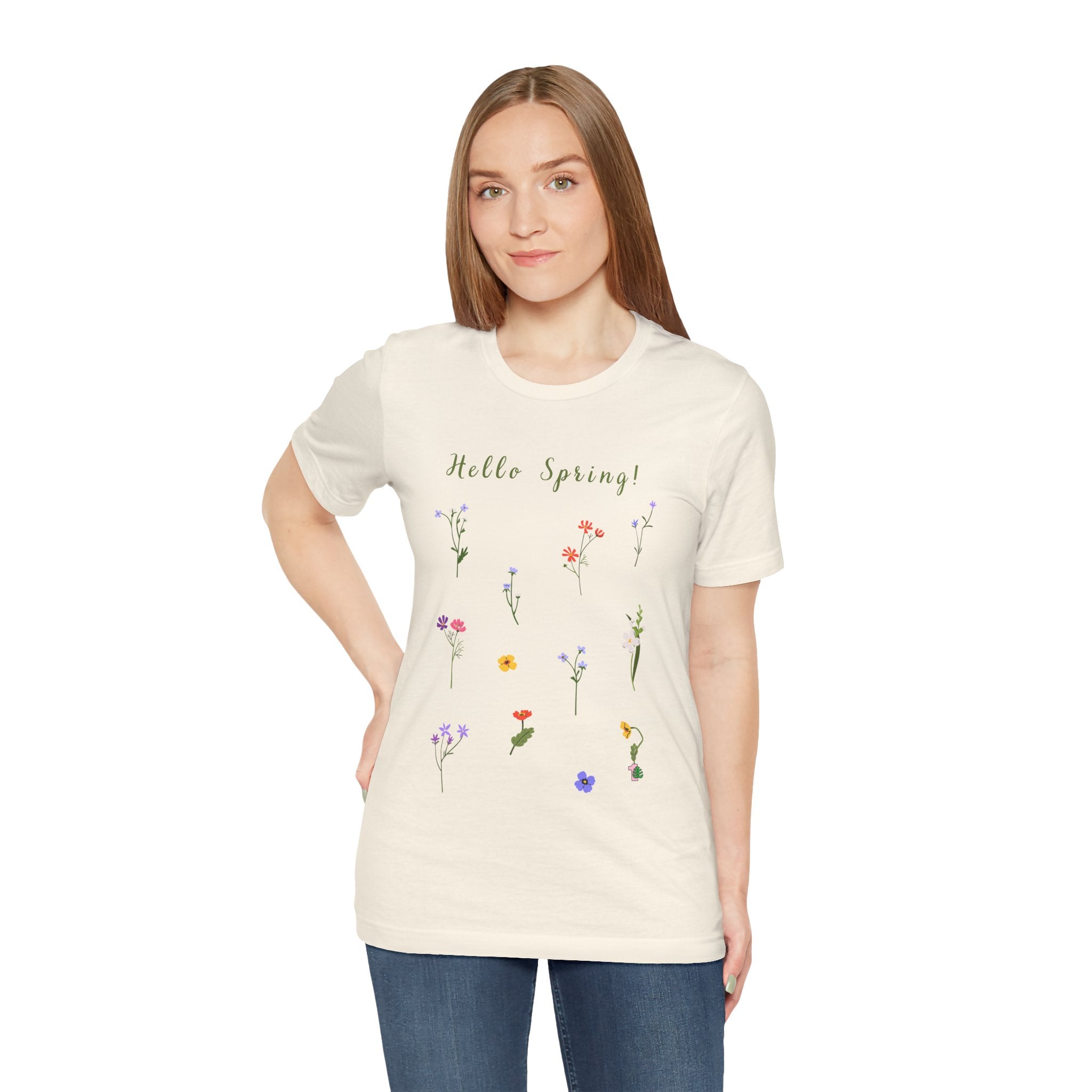 A woman wearing a natural colored tee shirt with wild flowers and text that says "Hello Spring!"