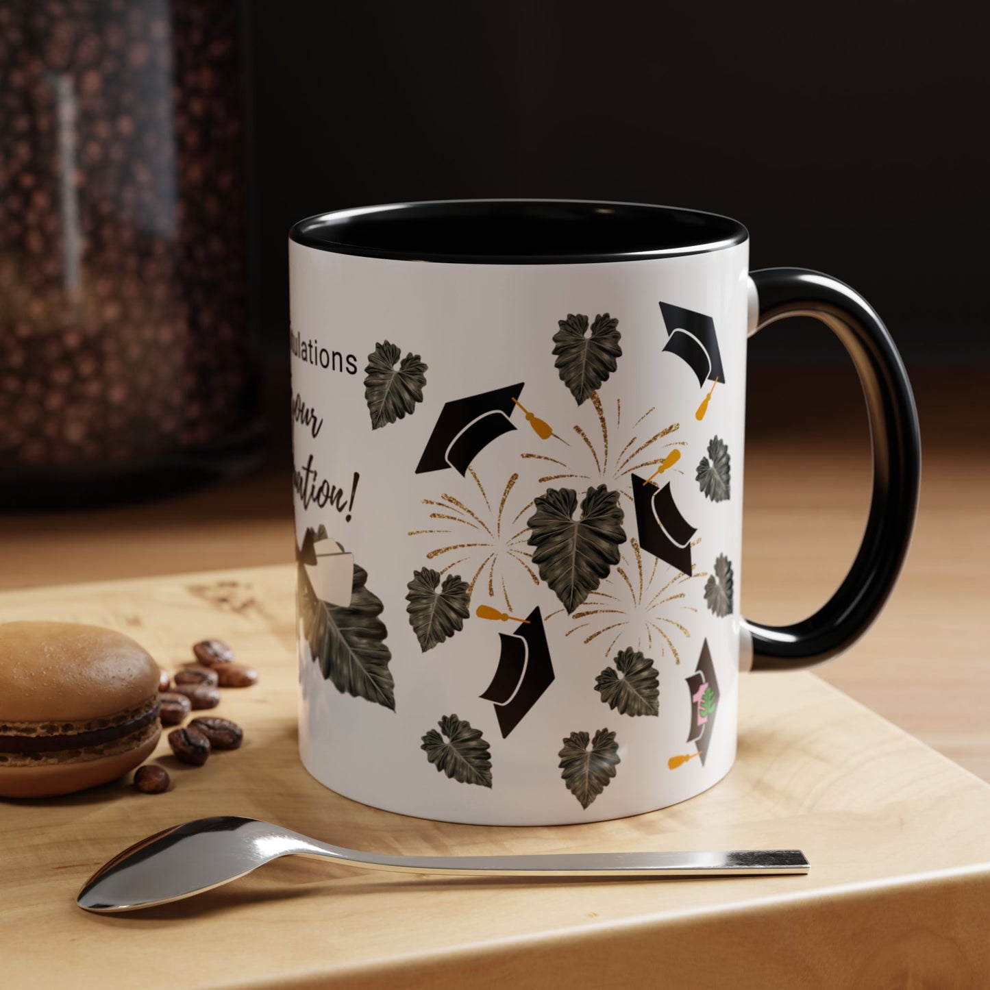 a mug with philodendron leaves and graduation caps