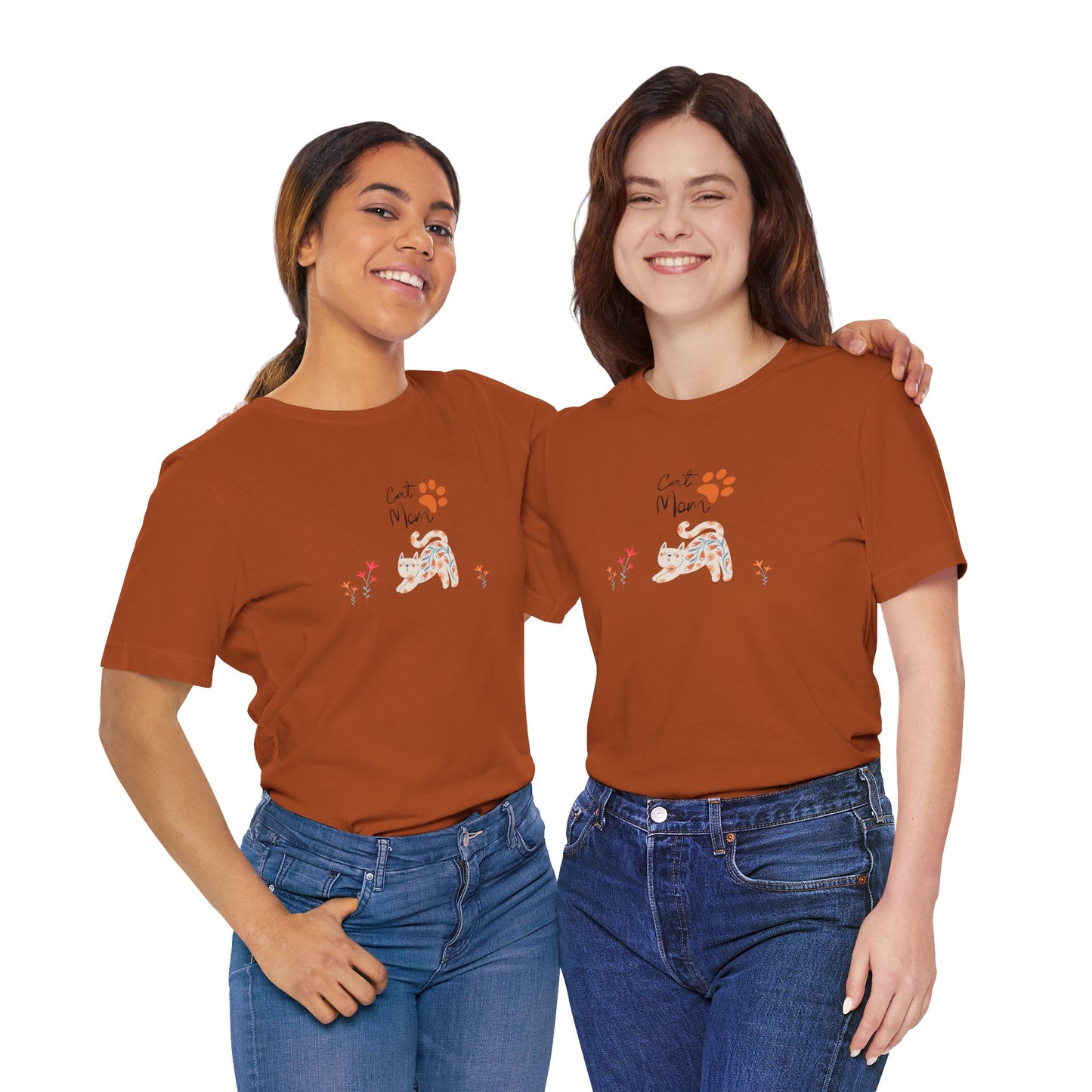 A woman wearing an autumn colored t-shirt with text that says "Cat Mom." There is also a cat print, a floral cat, and flowers around the cat design.