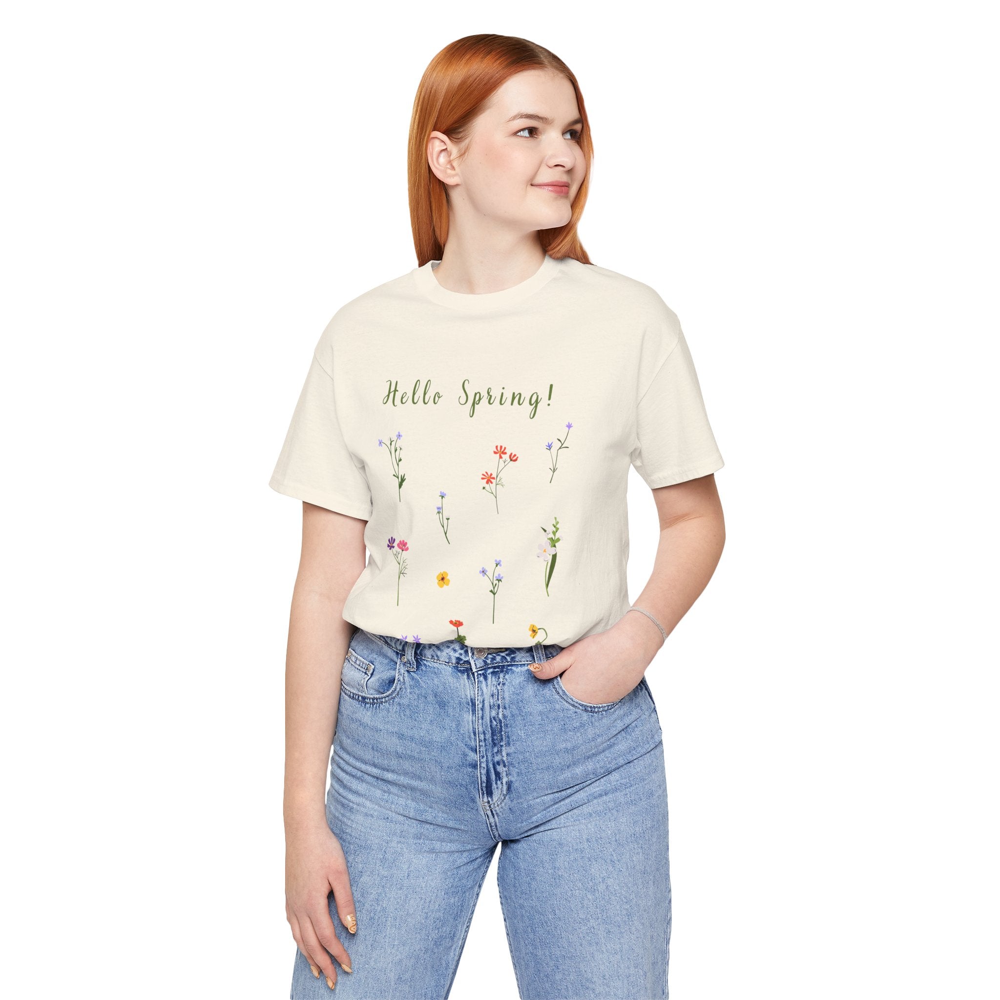 A college student wearing a casual tee with wild flowers and text that says "Hello Spring!"