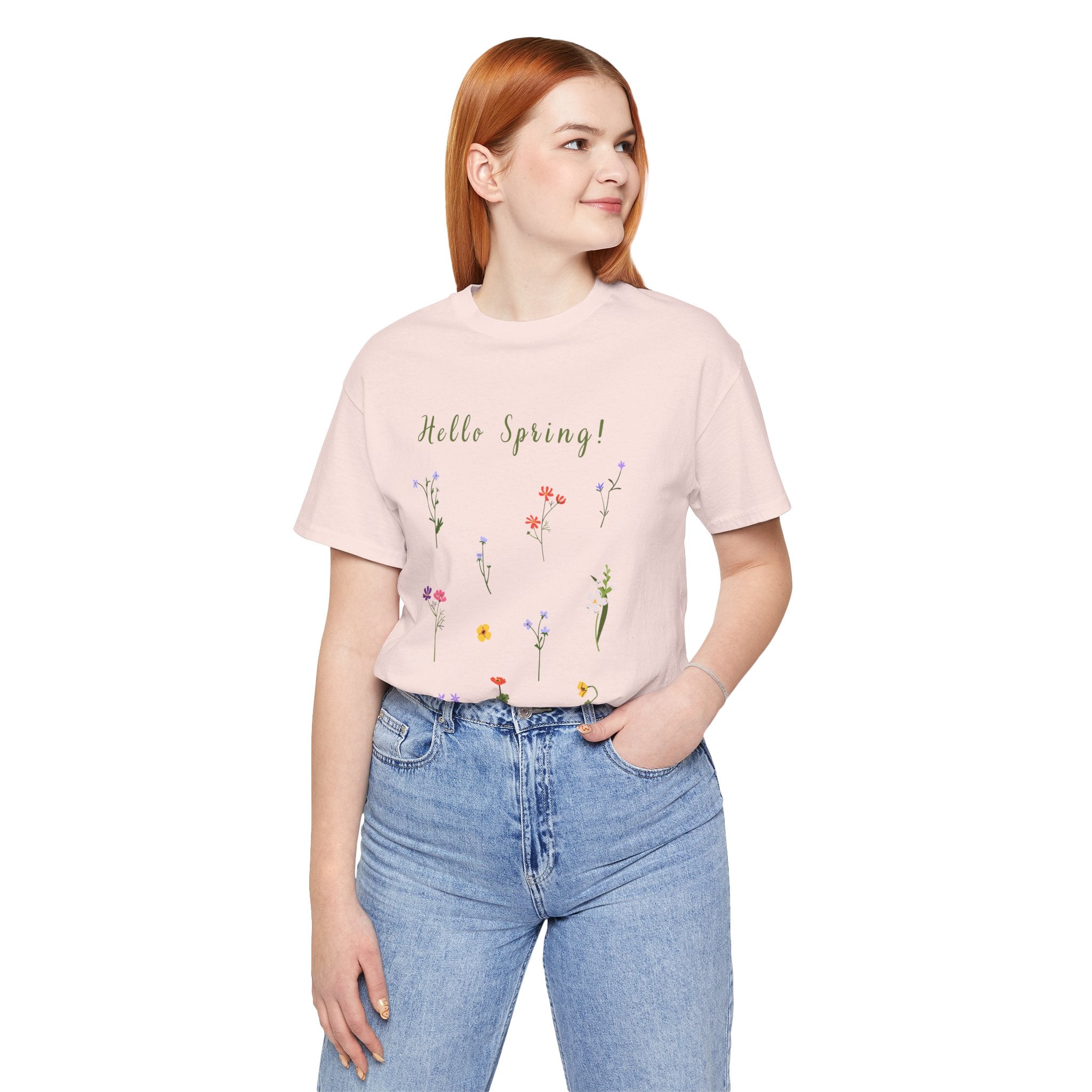 A woman wearing a casual and lightweight tee shirt with wild flowers and the text that says "Hello Spring!"