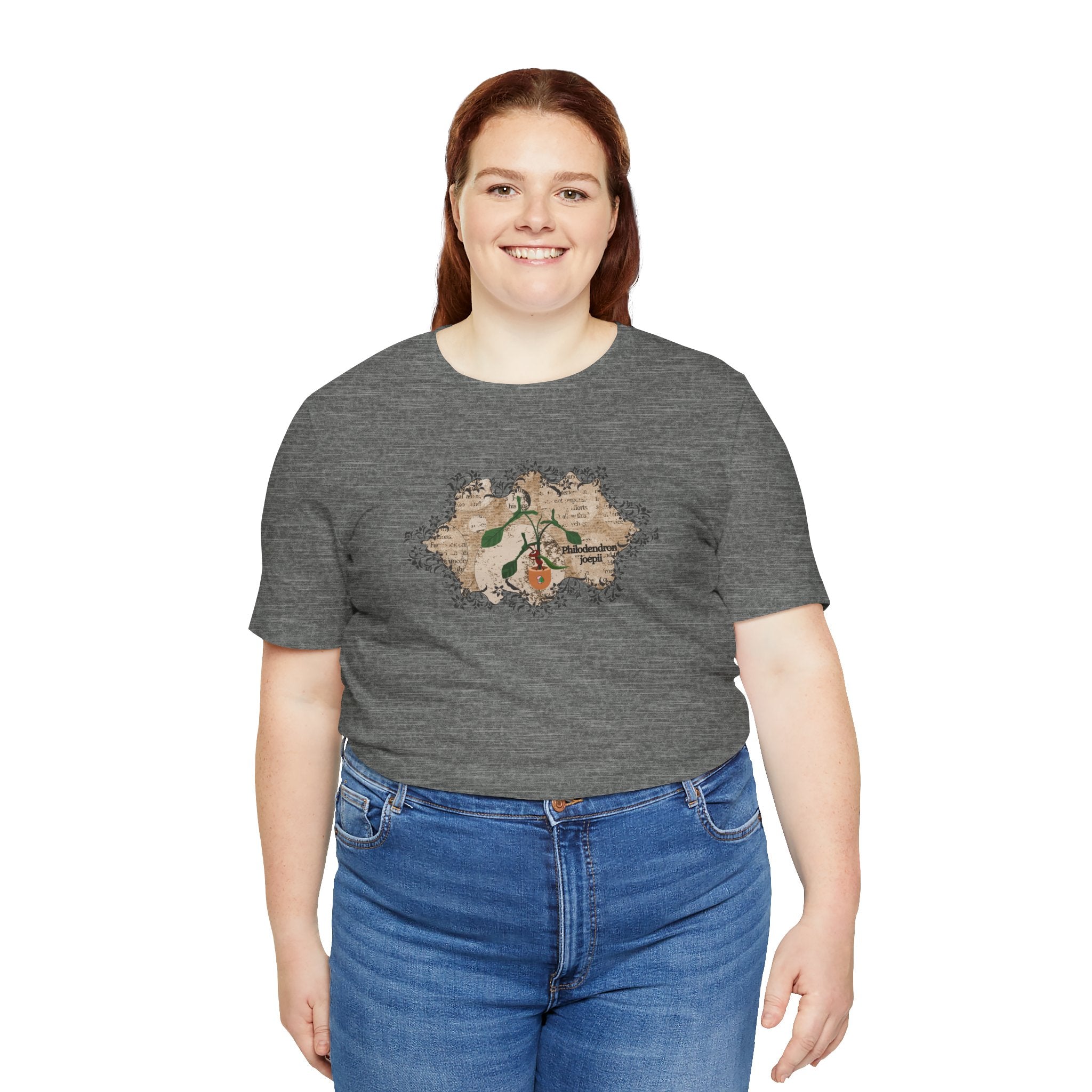 A lady wearing a plant t-shirt with a philodendron plant design. The philodendron joepii is printed on the t-shirt along with an ant eating the plant leaves.