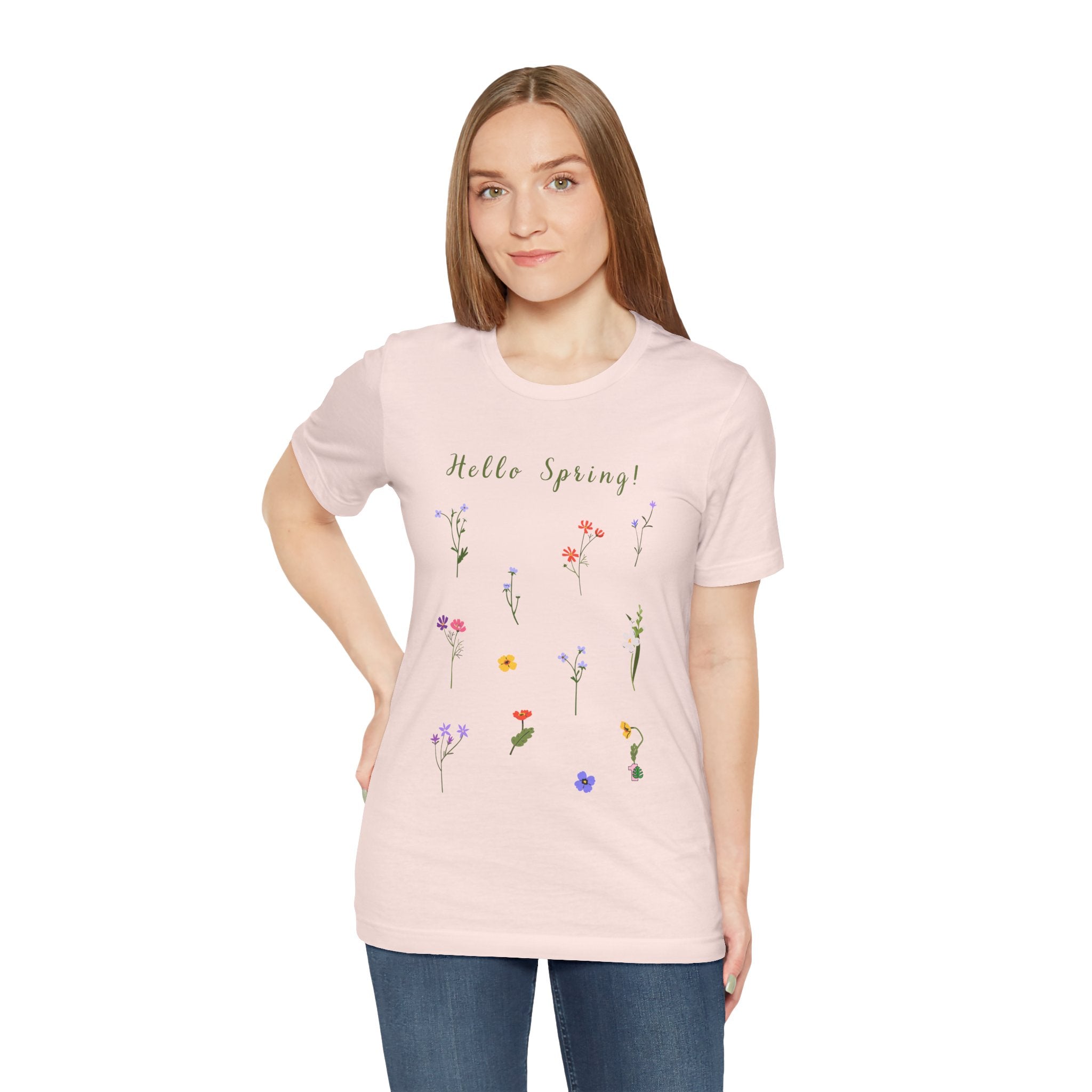 A woman wearing a casual tee shirt with wild flowers and the text that says "Hello Spring!"