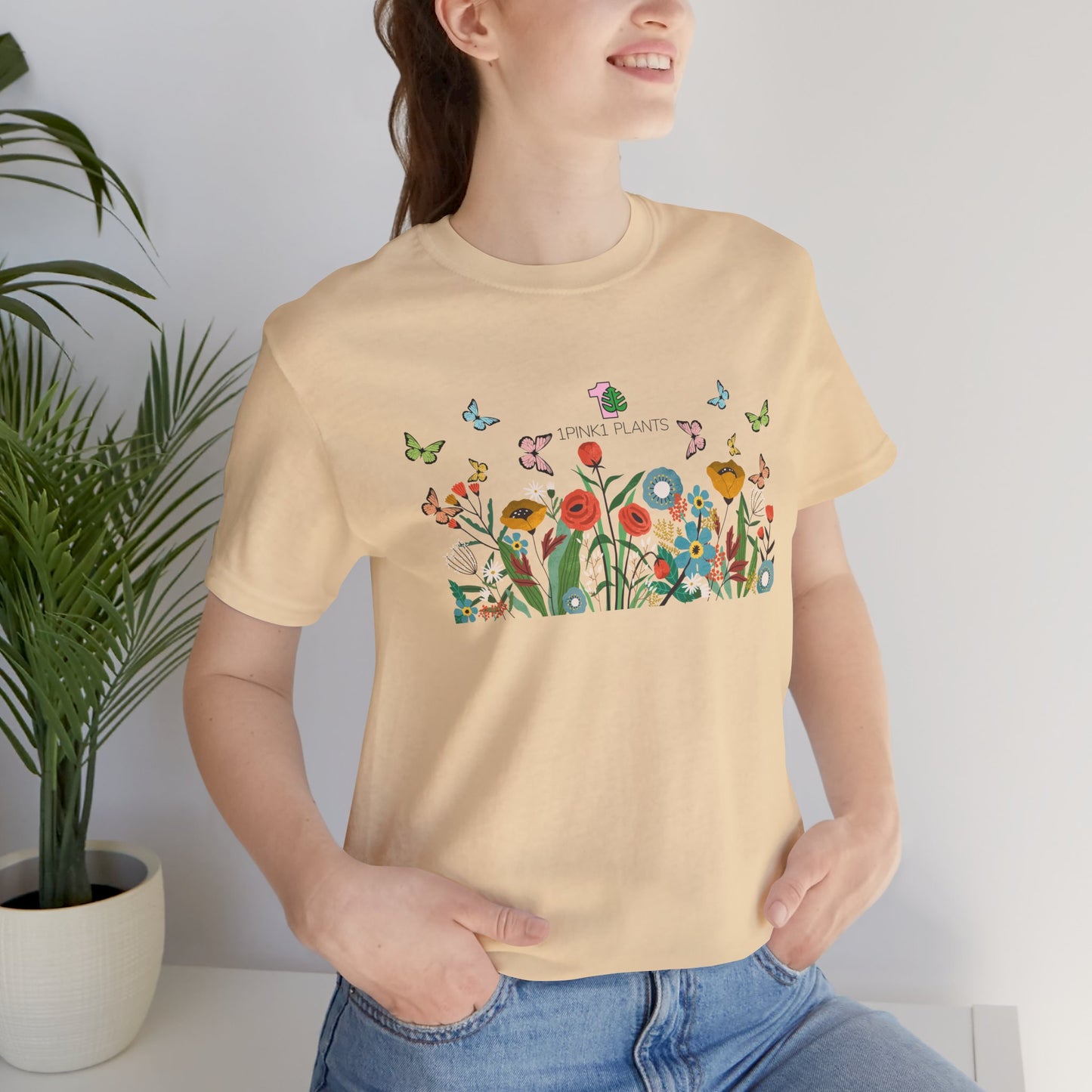 a lady wearing a garden shirt with flowers and butterflies.