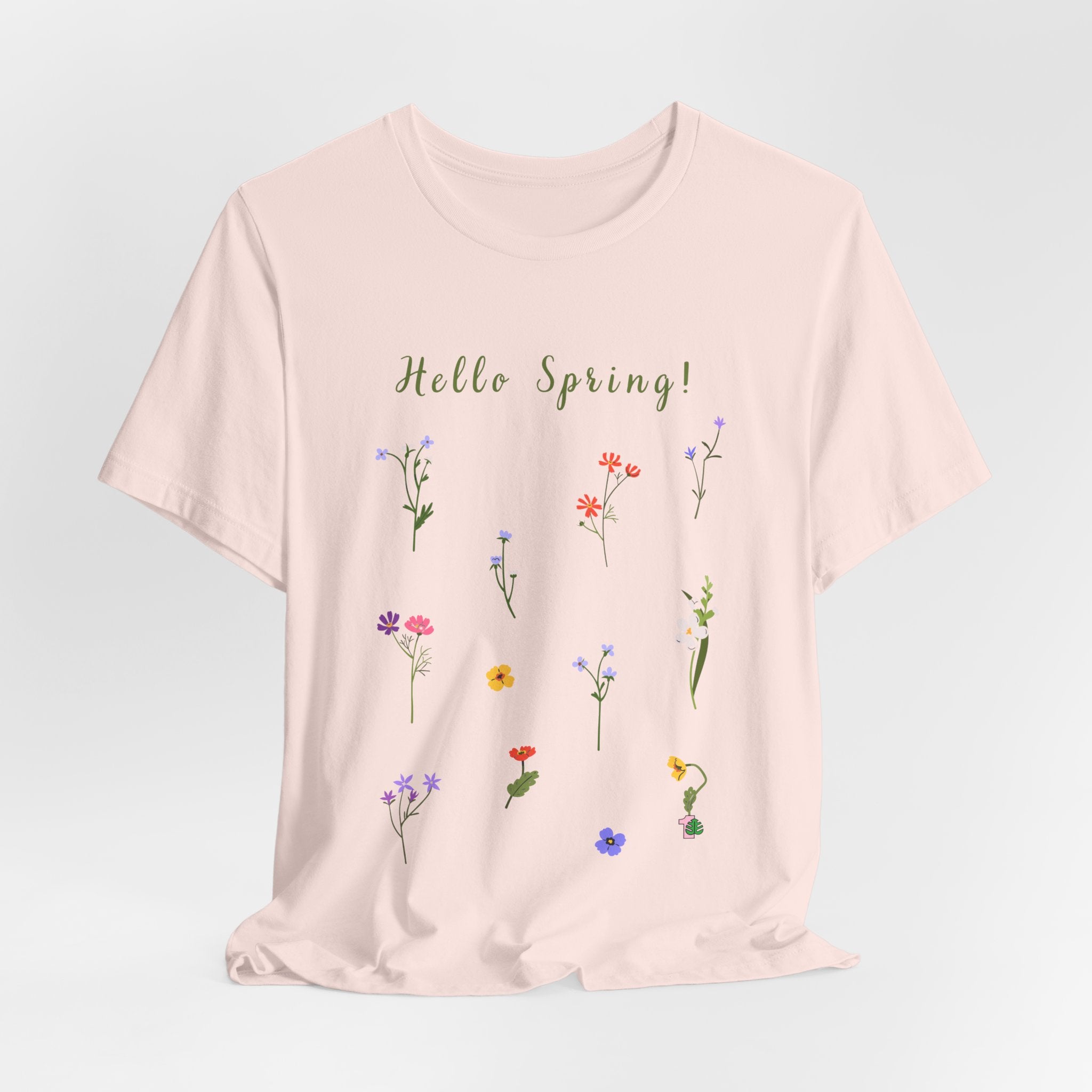 A casual tee shirt with wild flowers and the text that says "Hello Spring!"