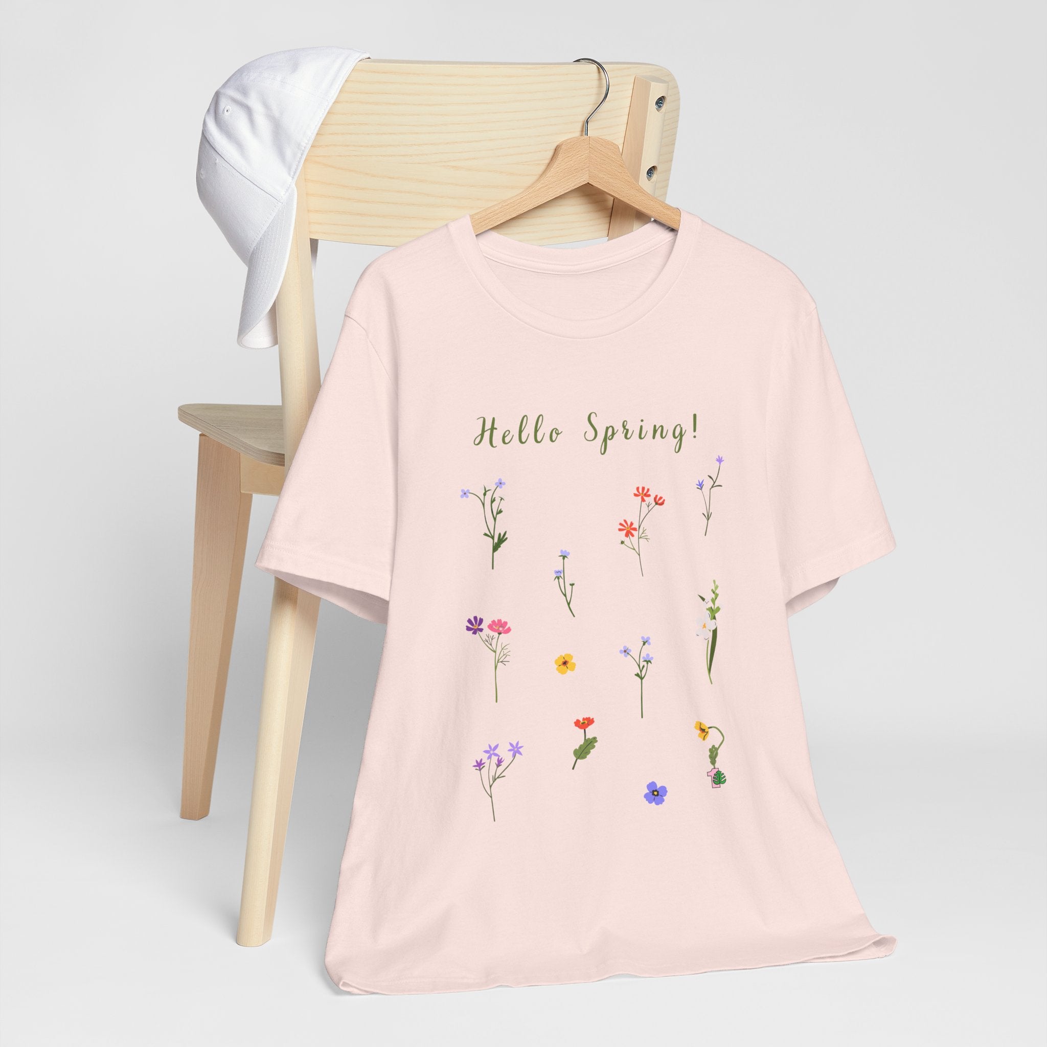 A light weight shirt with wild flowers and the text that says "Hello Spring!"