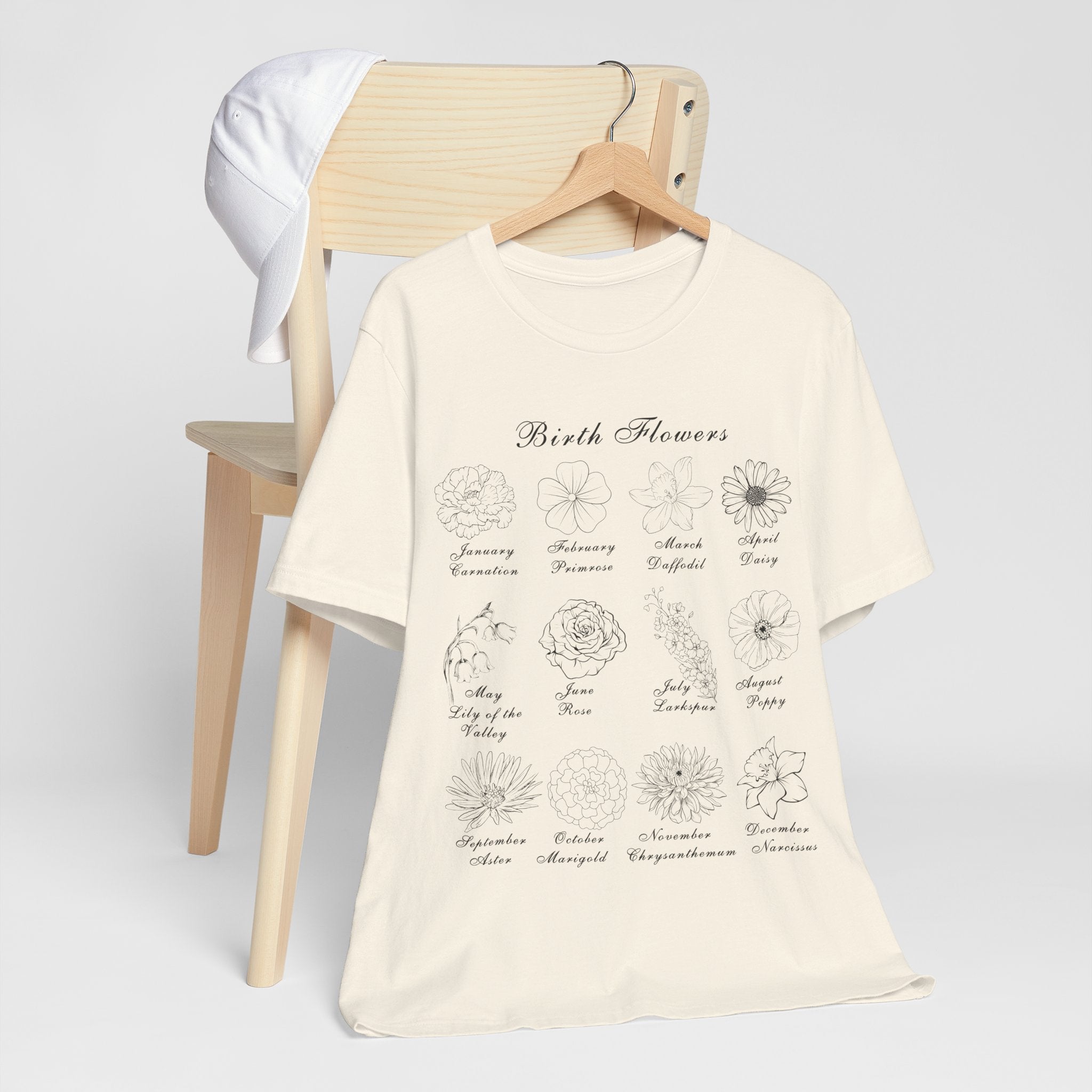 A shirt in a natural colored tone and a printed design of birth flowers.  Each month of the year is printed with a corresponding flower for that particular month.  The t-shirt has a crew neck and short sleeves.  It is also lightweight so it's perfect for layering.  It also makes an excellent birthday, Mother's Day, Valentine's Day or Christmas gift.