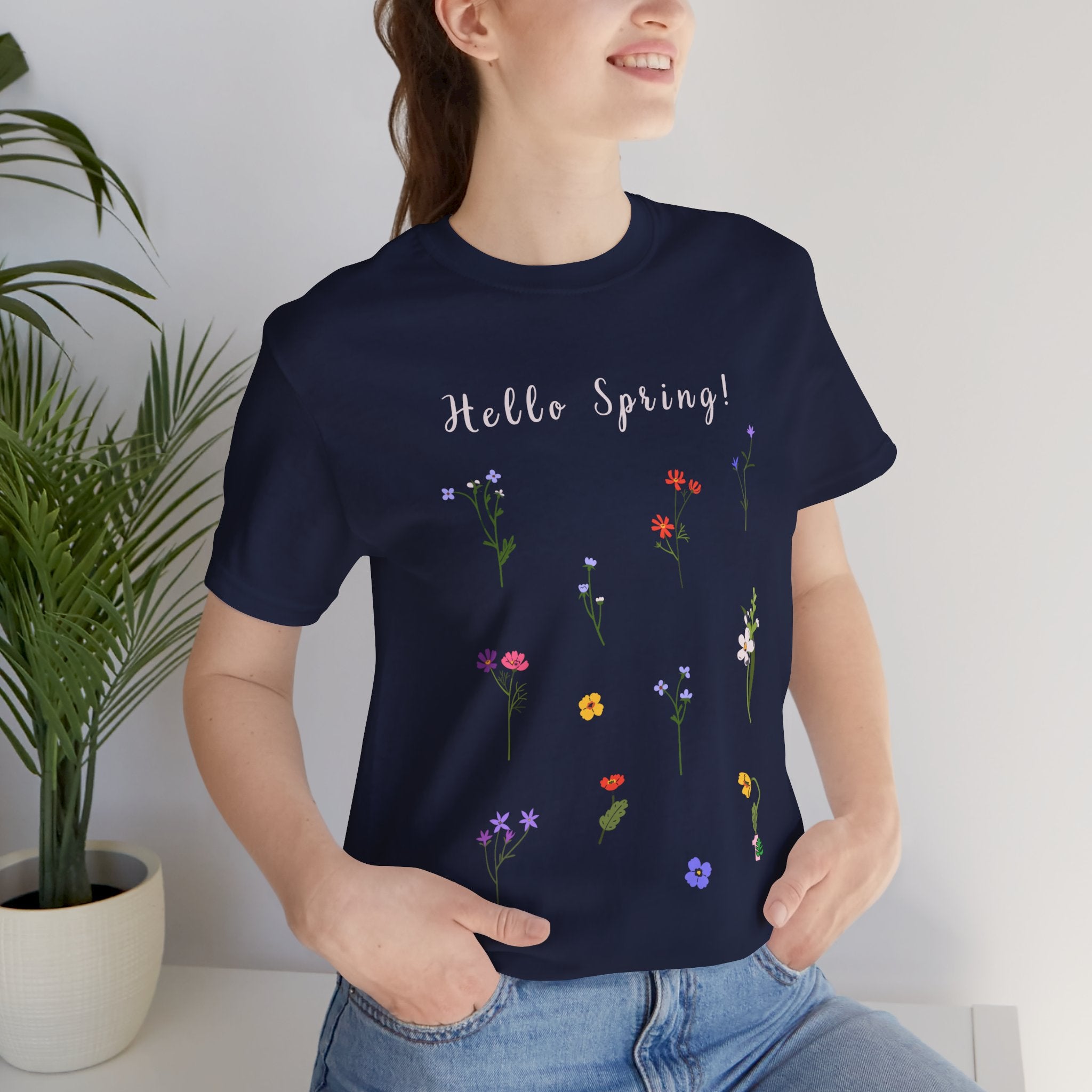 A navy t-shirt with the words "Hello Spring!" Perfect for wearing in the summer or winter when layering.