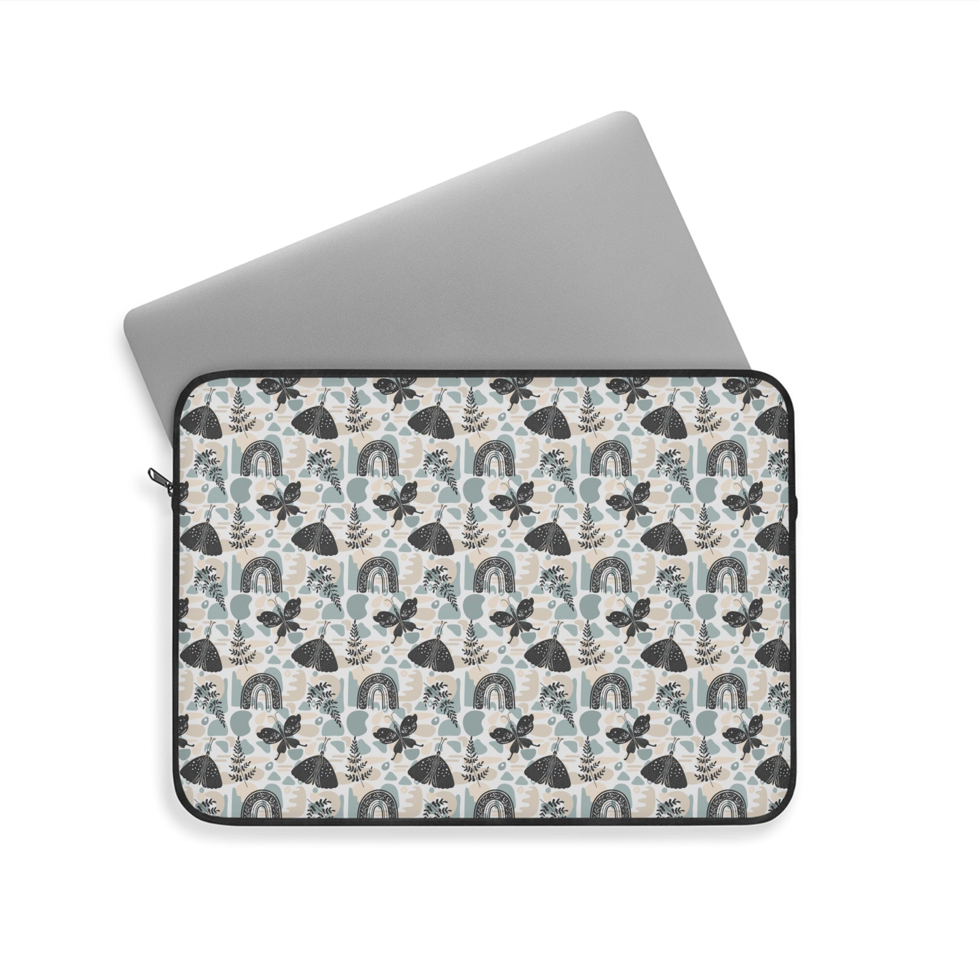 A cute boho chic style laptop sleeve with rainbows, plant leaves, and butterflies design. 