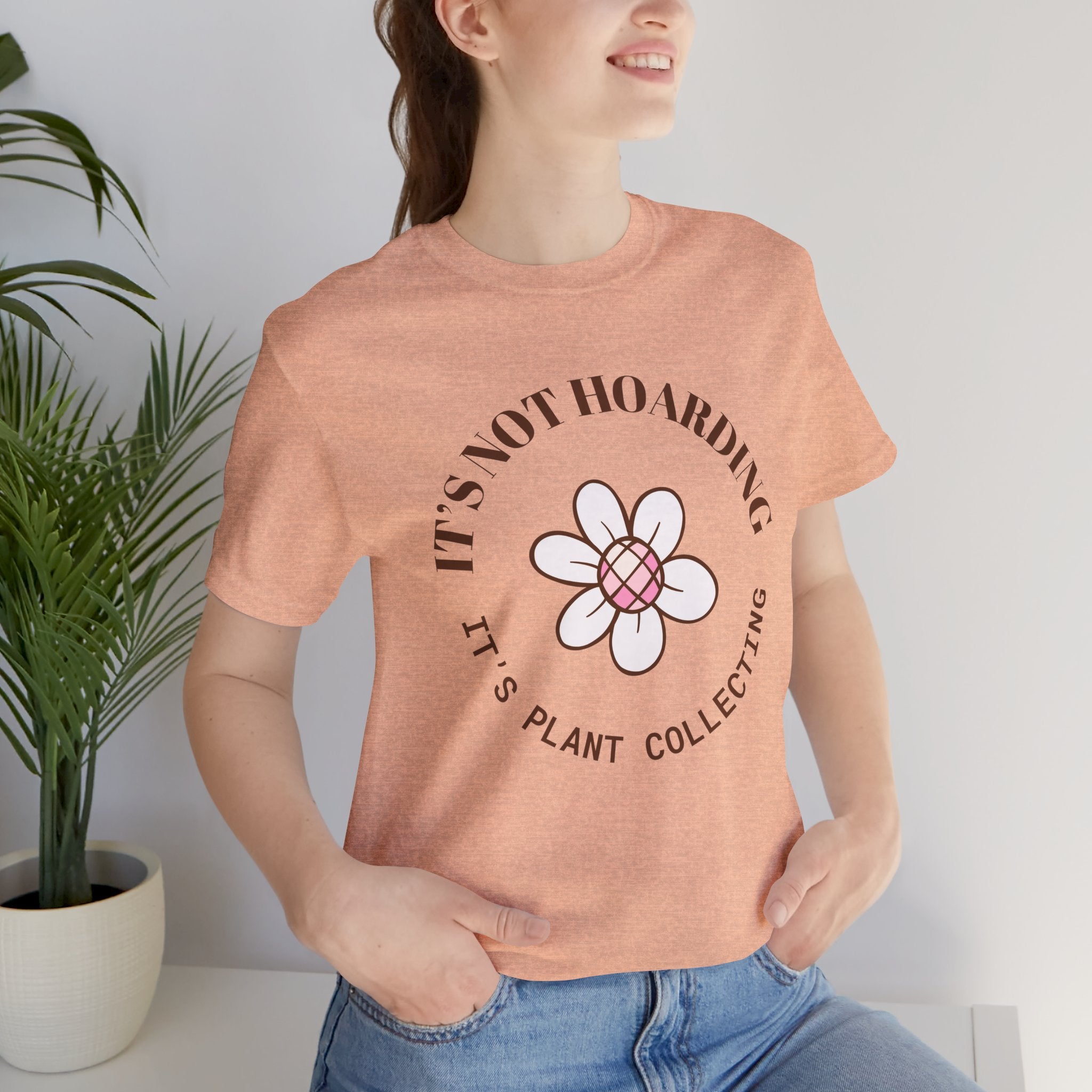 a woman wearing a t-shirt with text that says "It's not hoarding, it's plant collecting"