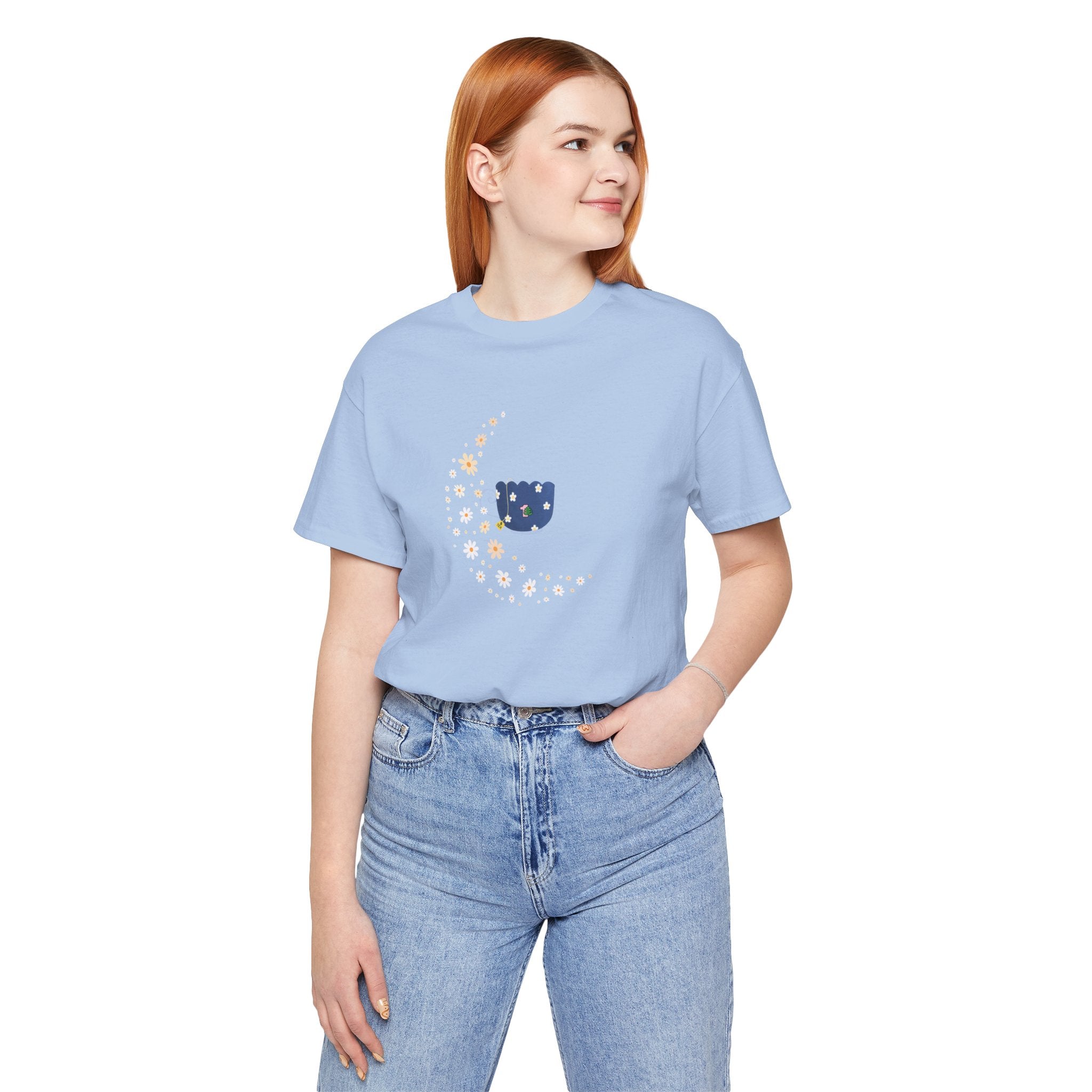 A person wearing a floral moon and floral tea cup design printed on a baby blue shirt.