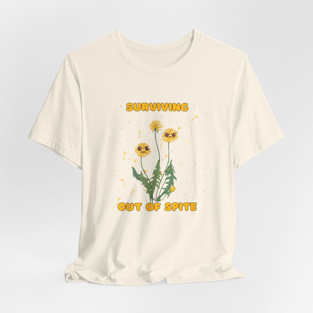 A natural color graphic t-shirt with yellow "surviving out of spite" funny text and dandelion plants with a funny look printed on the front of the shirt. 