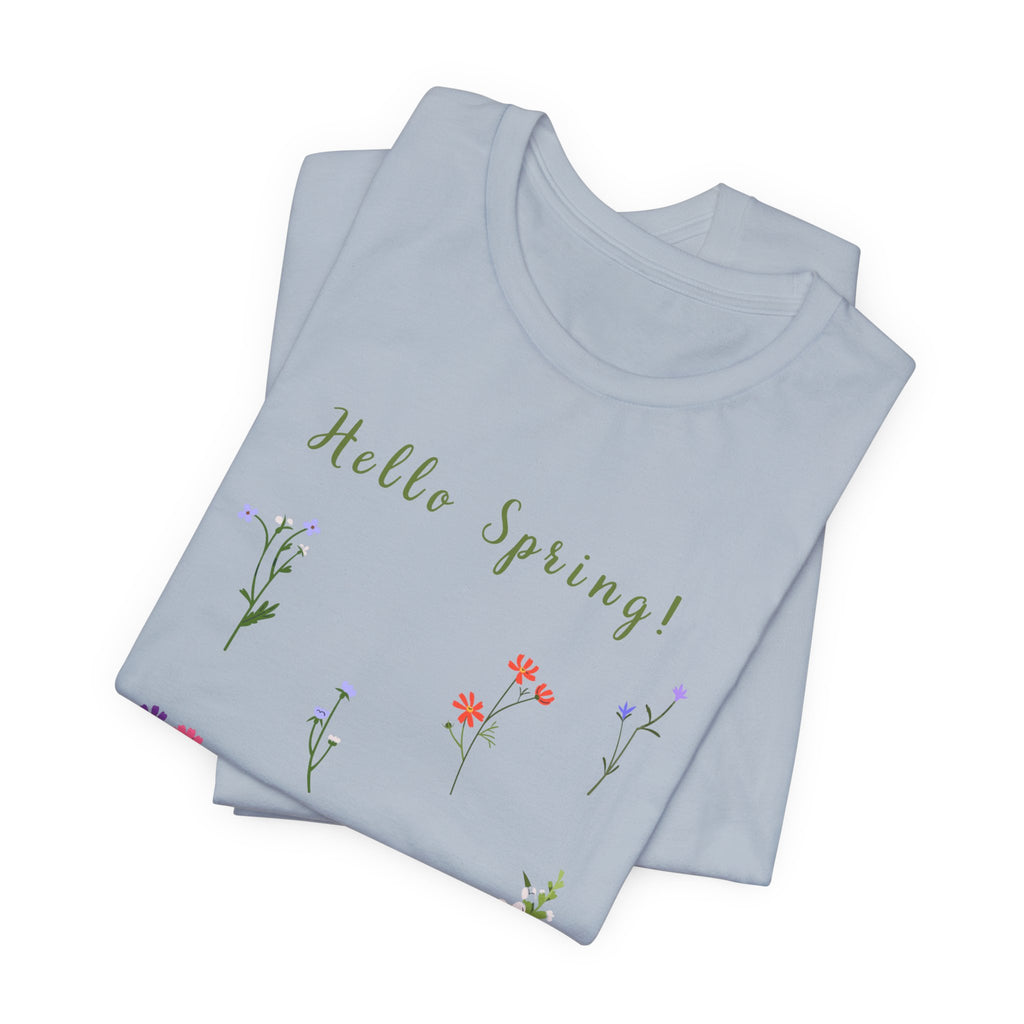 A folded crew neck t-shirt with a wild flowers print and text that reads "Hello Spring!" 
