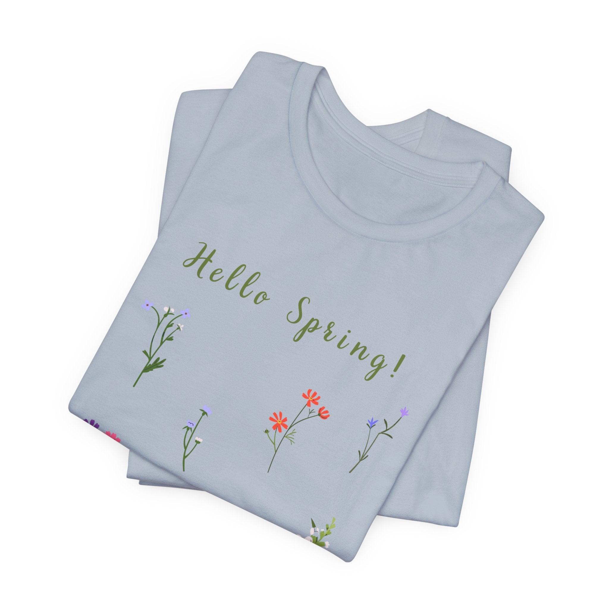 A folded crew neck t-shirt with a wild flowers print and text that reads "Hello Spring!" 