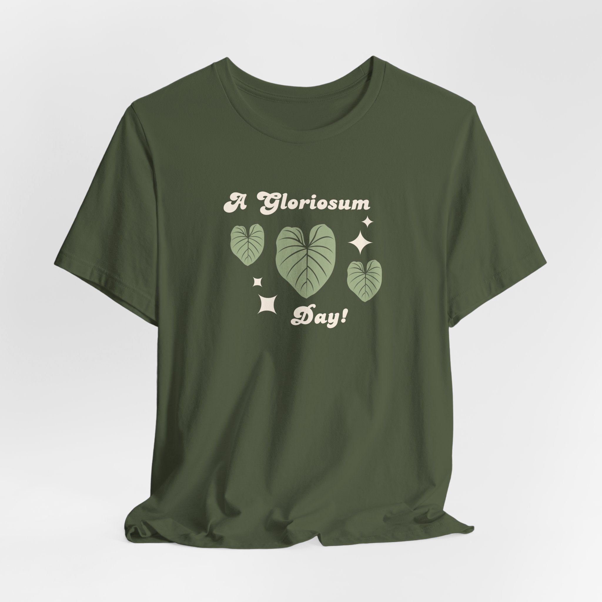 A military green tee shirt with text that says "A gloriosum day!"  The shirt design also has leaves from the philodendron gloriosum plant. 