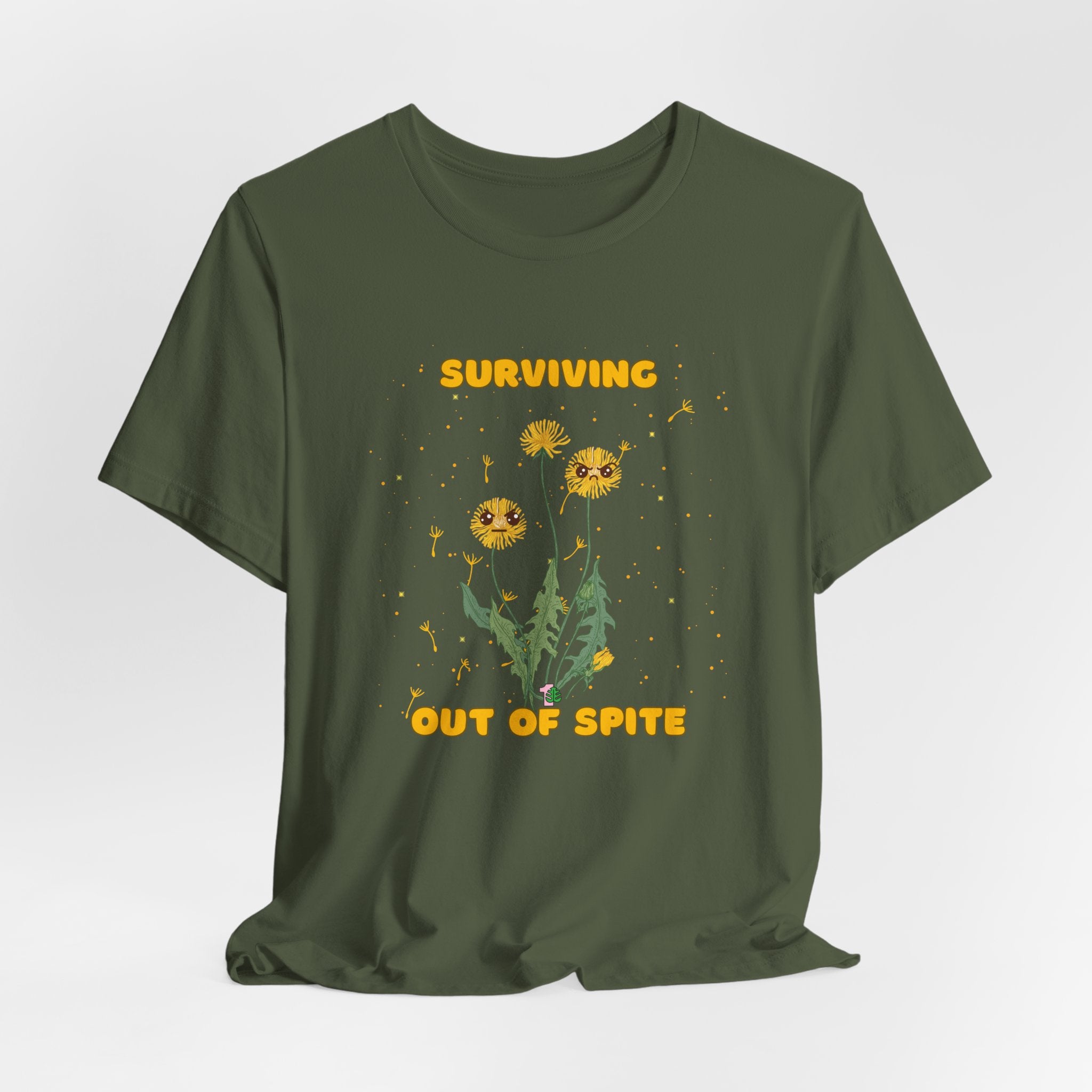 A military green color t-shirt with yellow "surviving out of spite" funny text.  There is also dandelion plants with a funny look printed on the front of the shirt. 