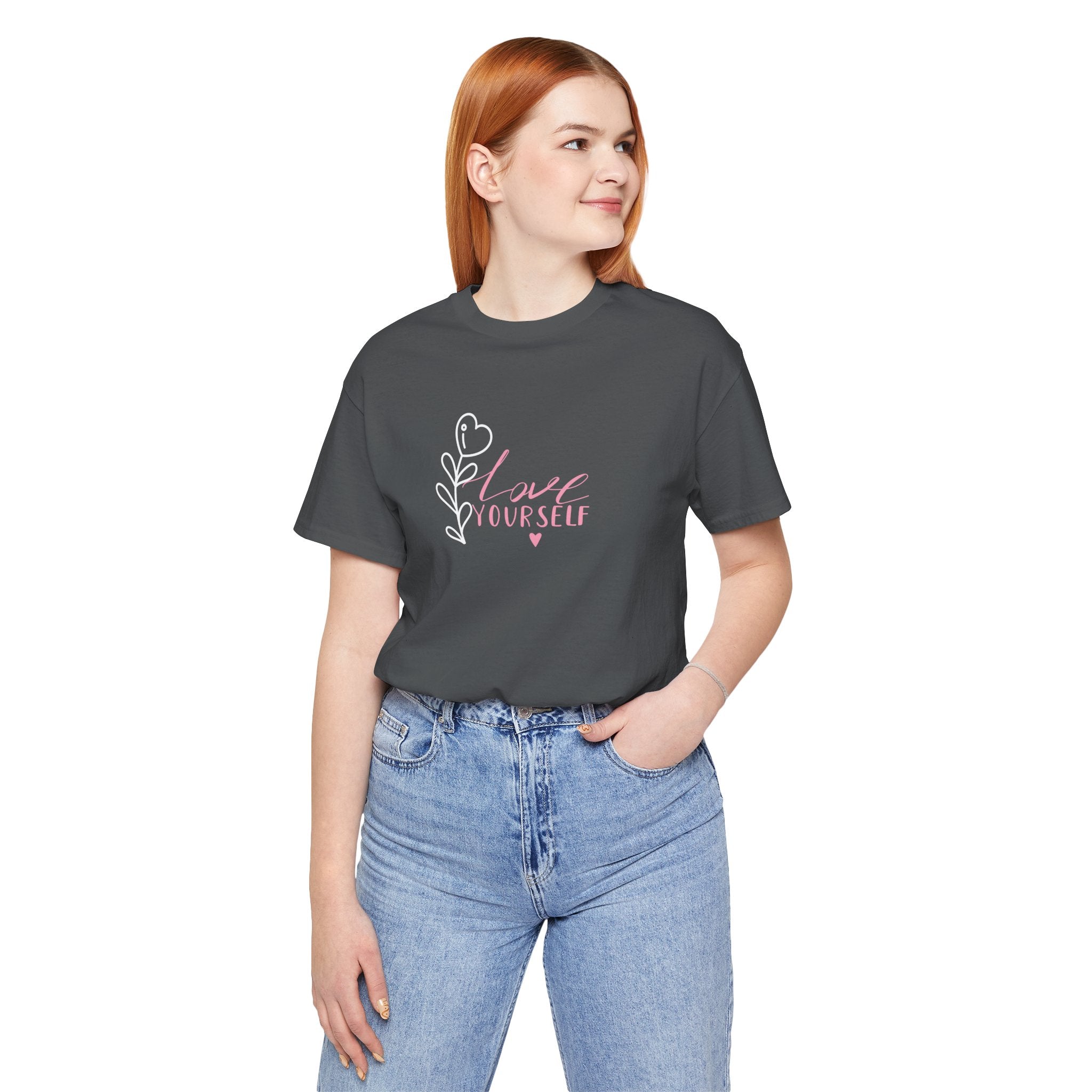 a person wearing an Asphalt colored tee shirt with pink text that says "love yourself".  