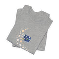 A tee-shirt featuring a floral moon and a teacup design.  It has a crew neck and short sleeves.  