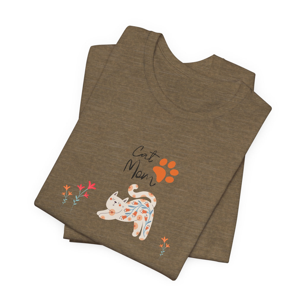 a folded heather olive t-shirt with the words "cat mom," a floral cat, and some flowers.