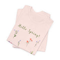 a folded t-shirt with the words "Hello Spring!"