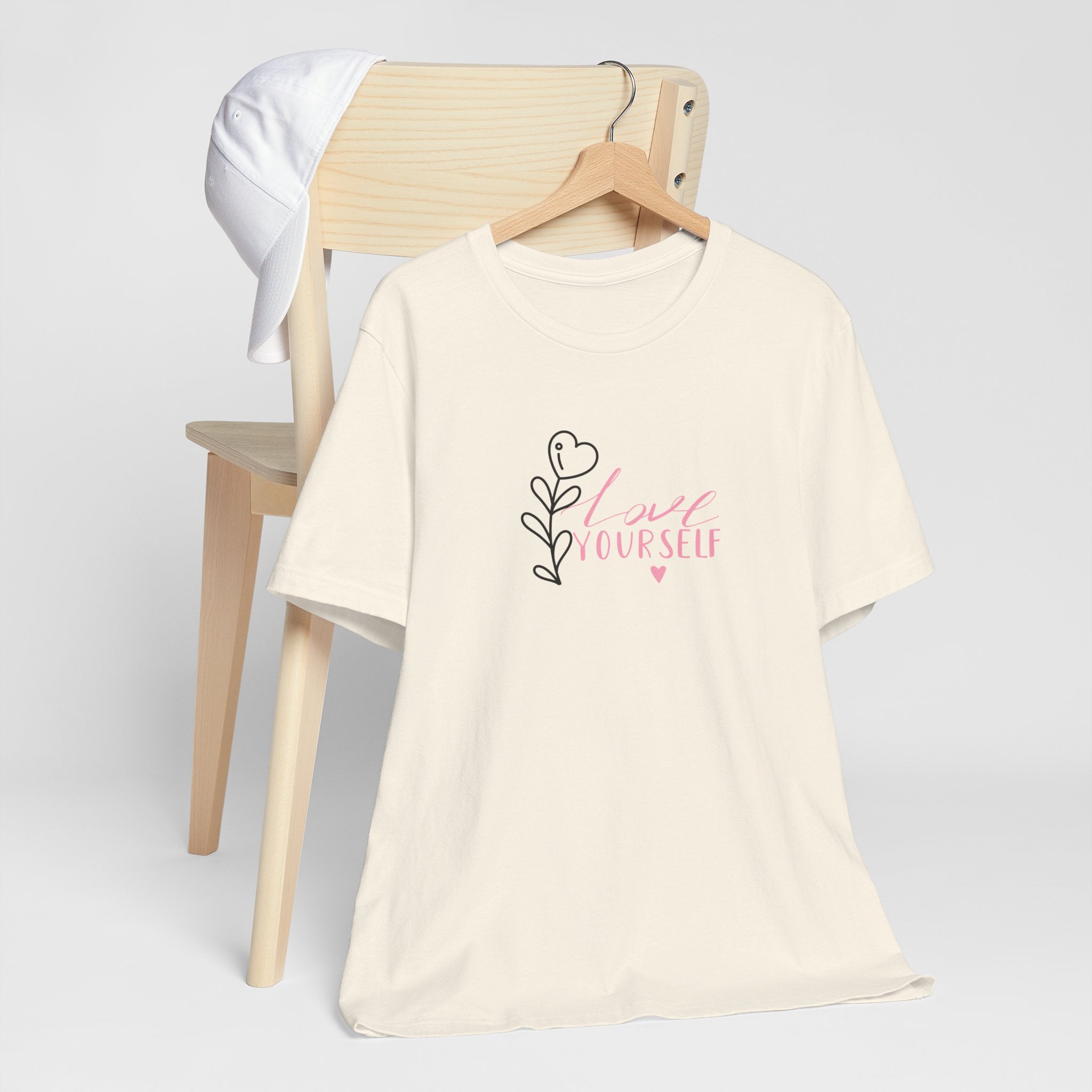 Picture of a natural color top with pink text that says "love yourself".  