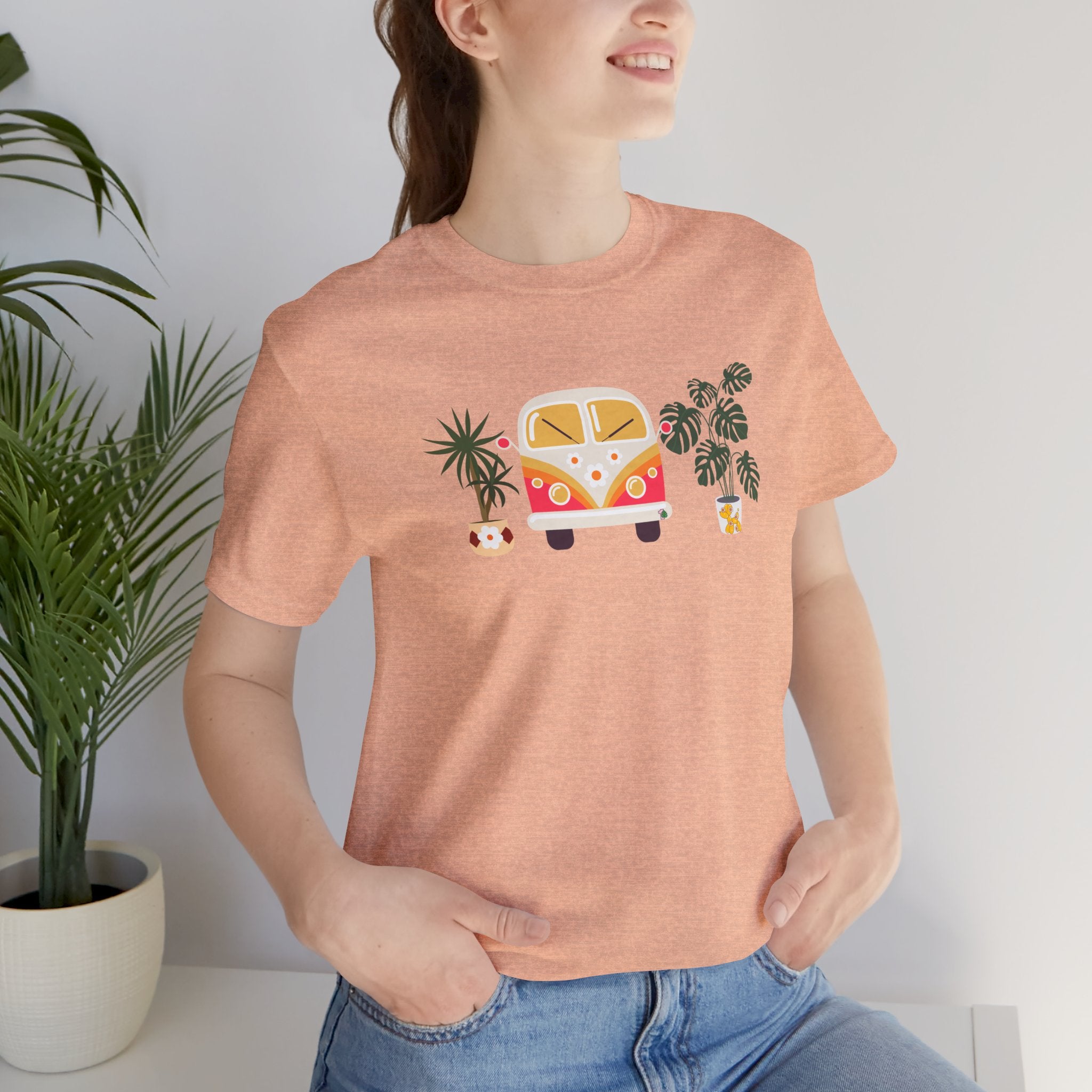 A person wearing a graphic tee with plant designs and a vintage buggy car. 
