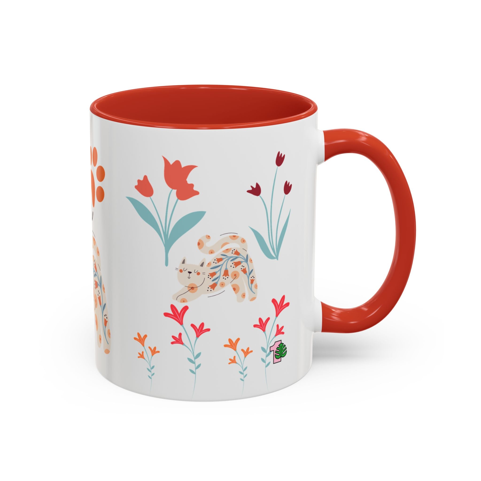 Mug with floral design and red interior and handle on a white background