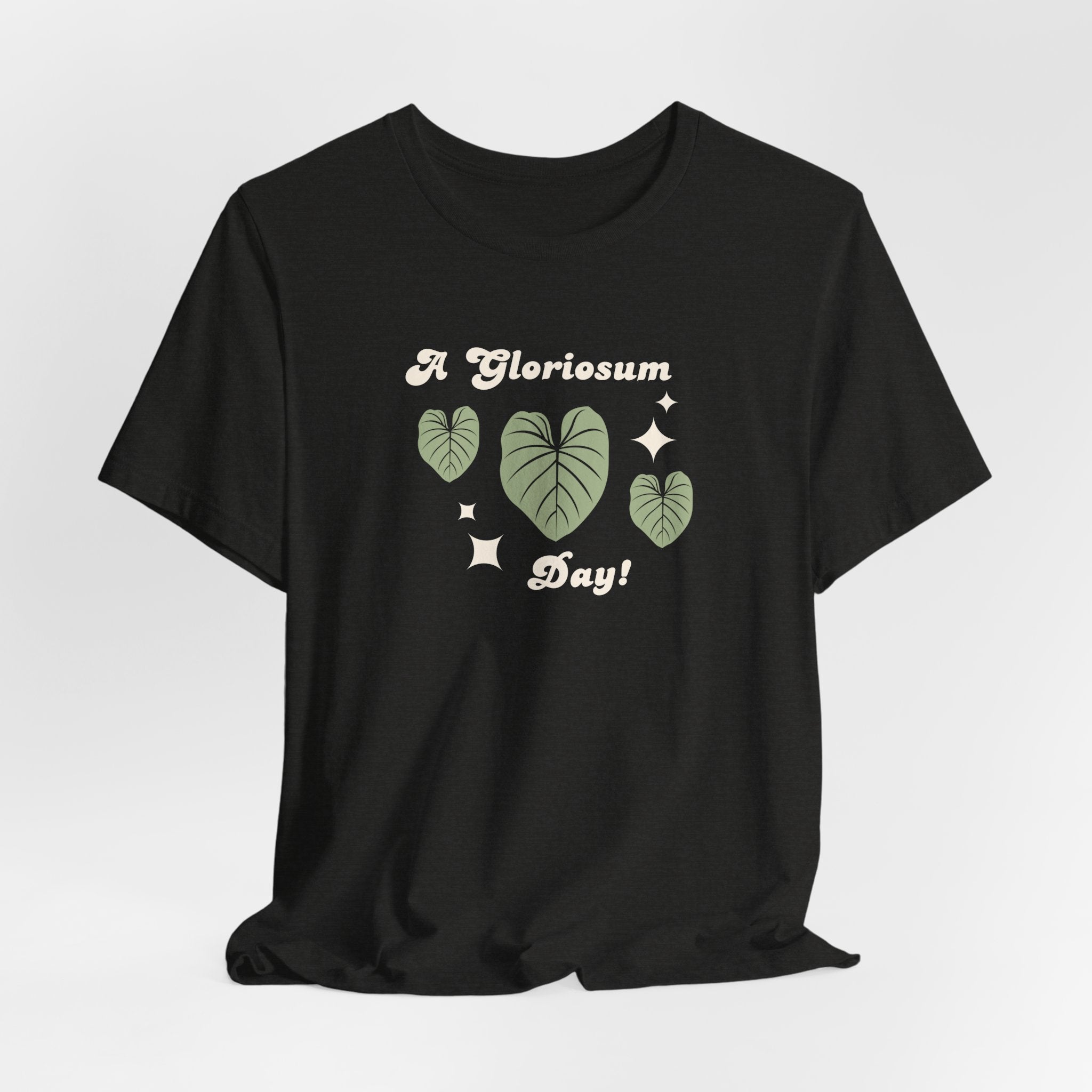 A plat t-shirt with a philodendron gloriosum houseplant design and text that says "A gloriosum Day!" An excellent gift for plant lovers, plant collectors, and plant enthusiasts. Great as a birthday gift. This folded t-shirt comes in a black Heather color.