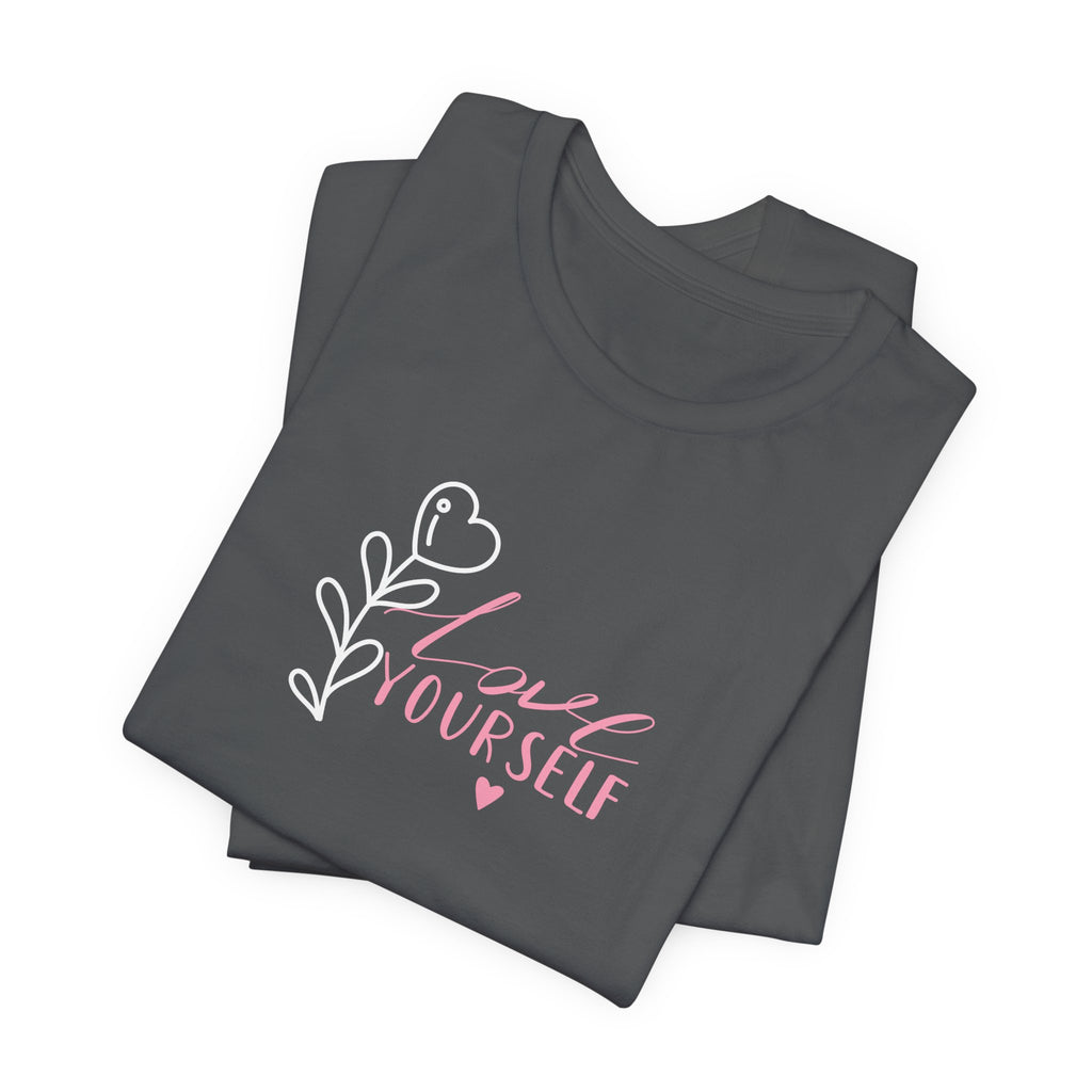Picture of folded Asphalt colored tshirt with pink text that says "love yourself".  