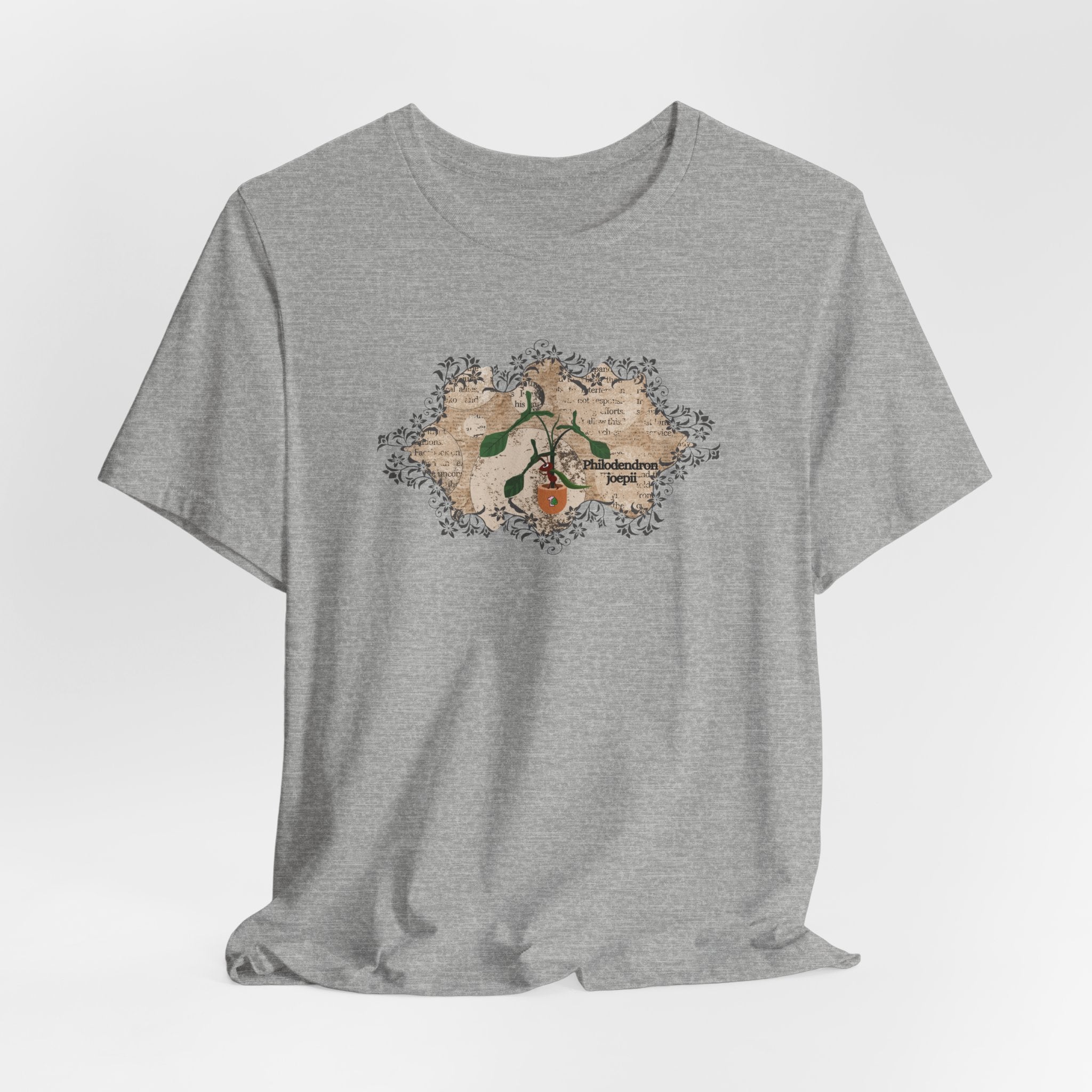 A tee shirt with a philodendron joepii plant design, an ant eating the plant, and the 1pink1 plants logo. Perfect plant t-shirt for plant lovers