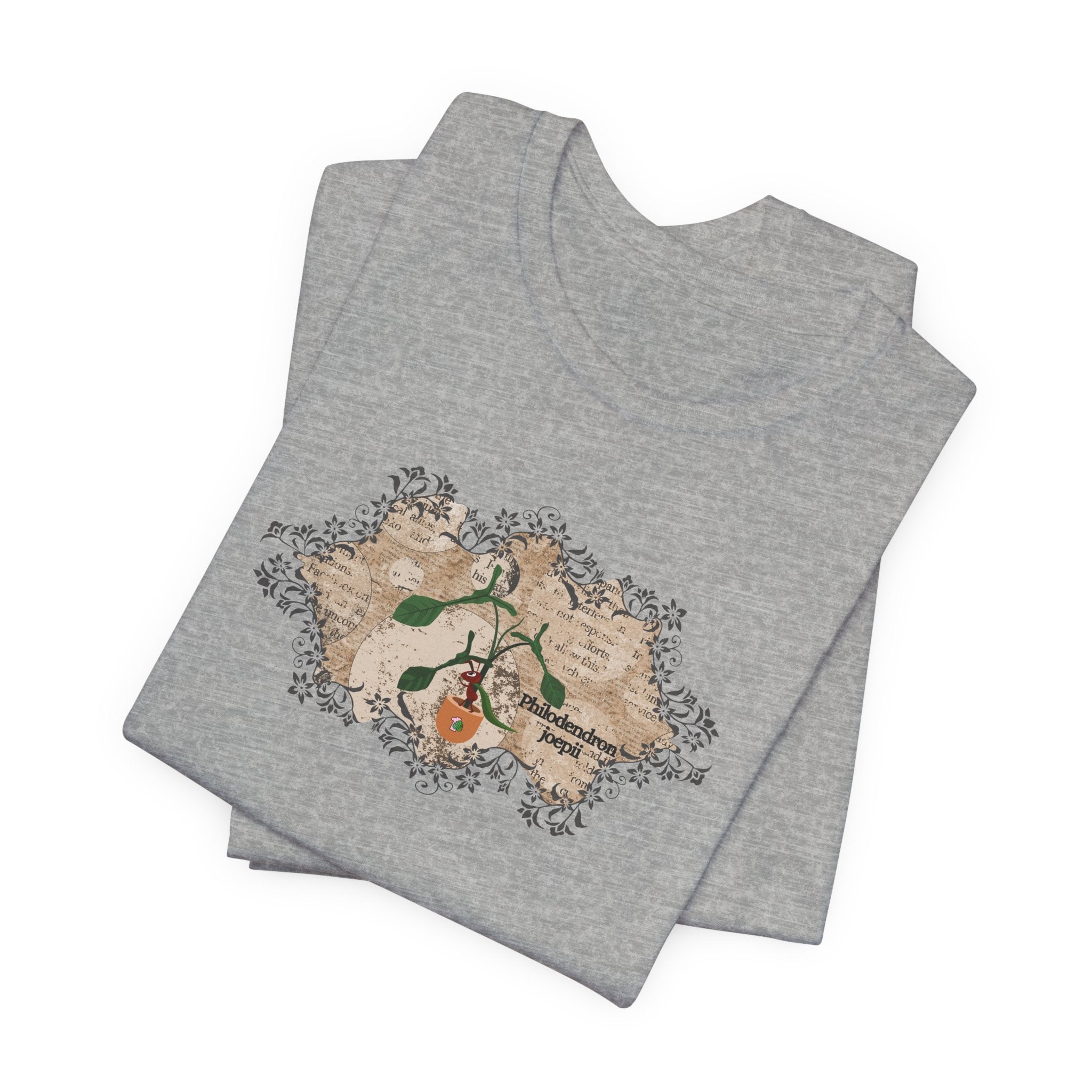 A folded t-shirt with a philodendron joepii plant design.