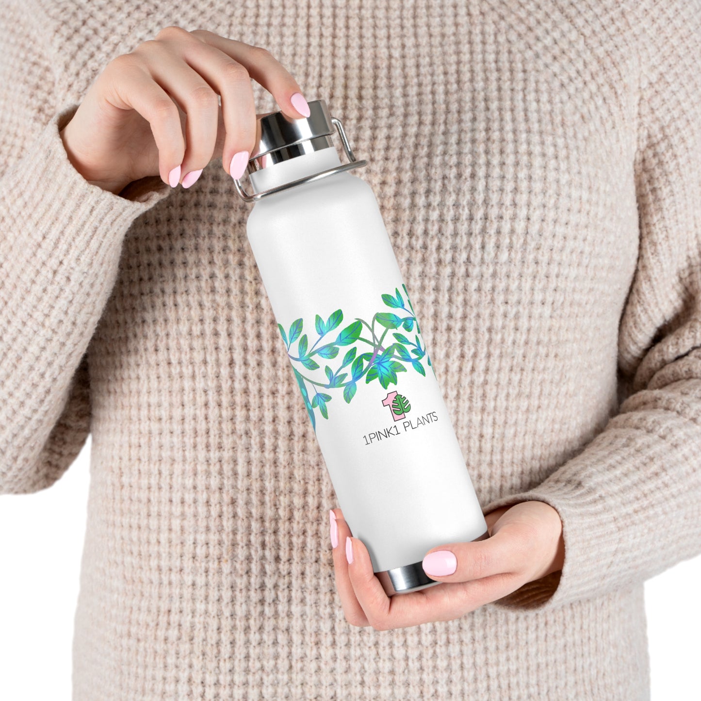 Person holding a white water bottle with a green aqua leaf design and brand logo "1PINK1 PLANTS".