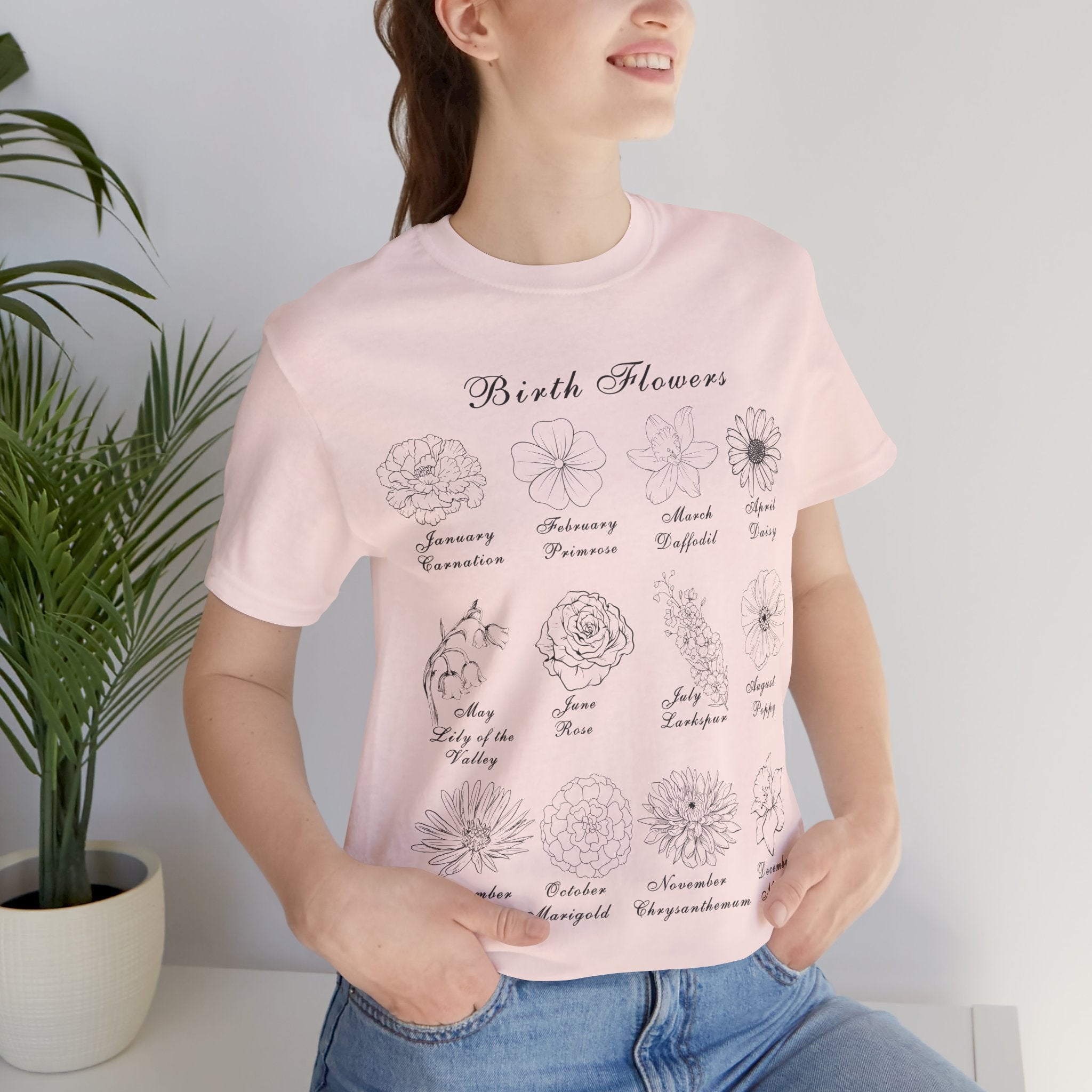 A soft pink colored top with a printed design of birth flowers.  Each month of the year is printed with a corresponding flower for that particular month.  The t-shirt has a crew neck and short sleeves.  It is also lightweight so it's perfect for layering.  It also makes an excellent birthday, Mother's Day, Valentine's Day or Christmas gift. 