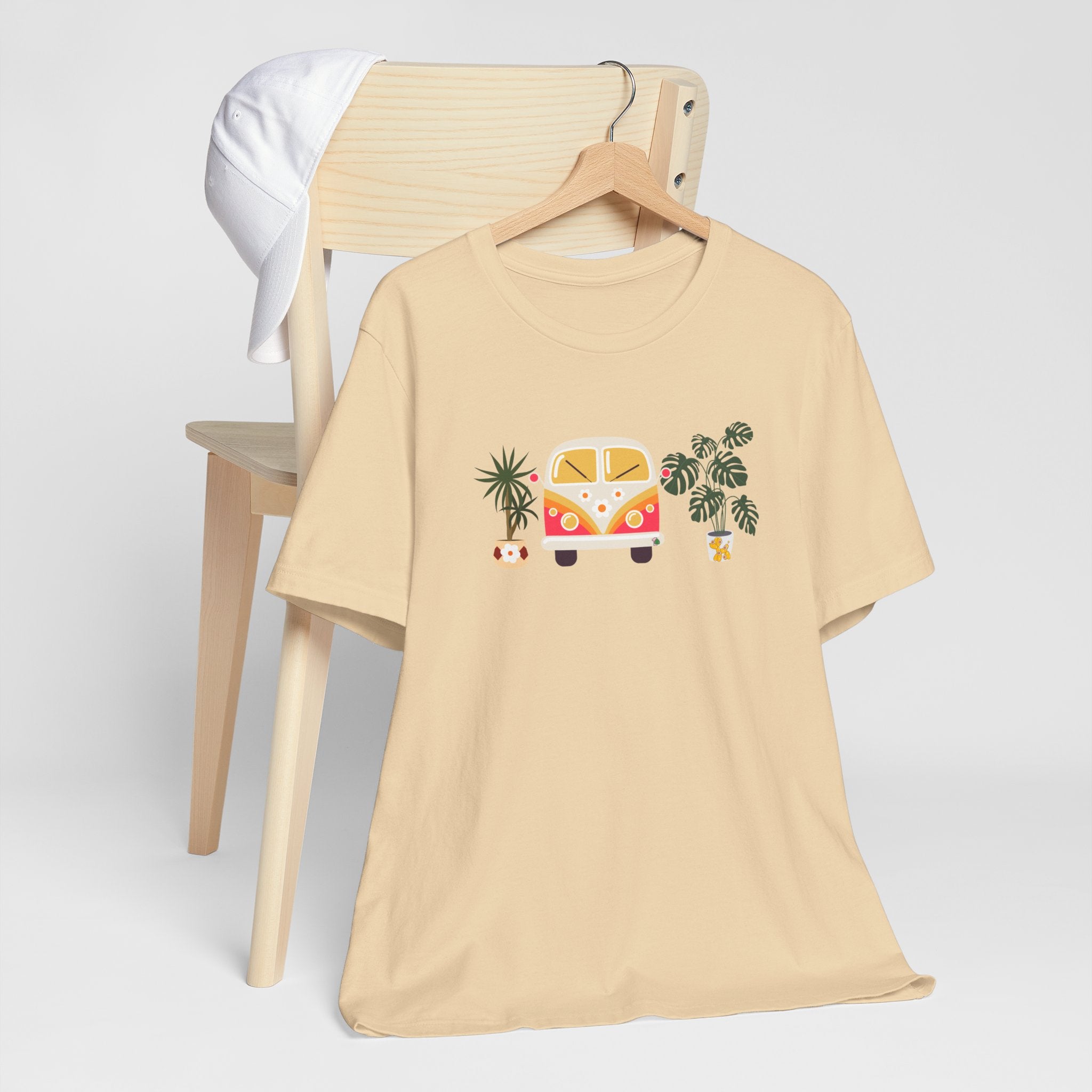 A graphic tee with plant designs and a vintage buggy car. 