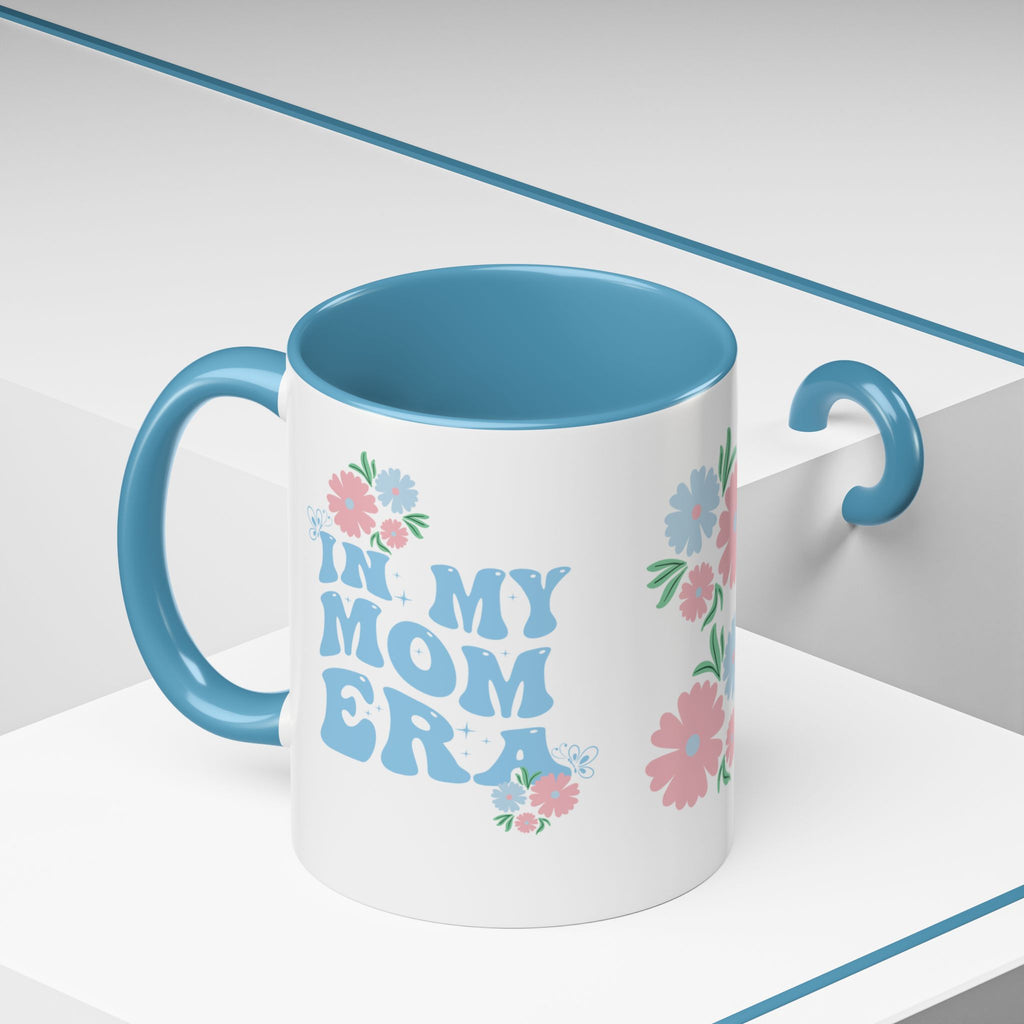 Mug with 'In My Mom Era' text and floral designs on a white background