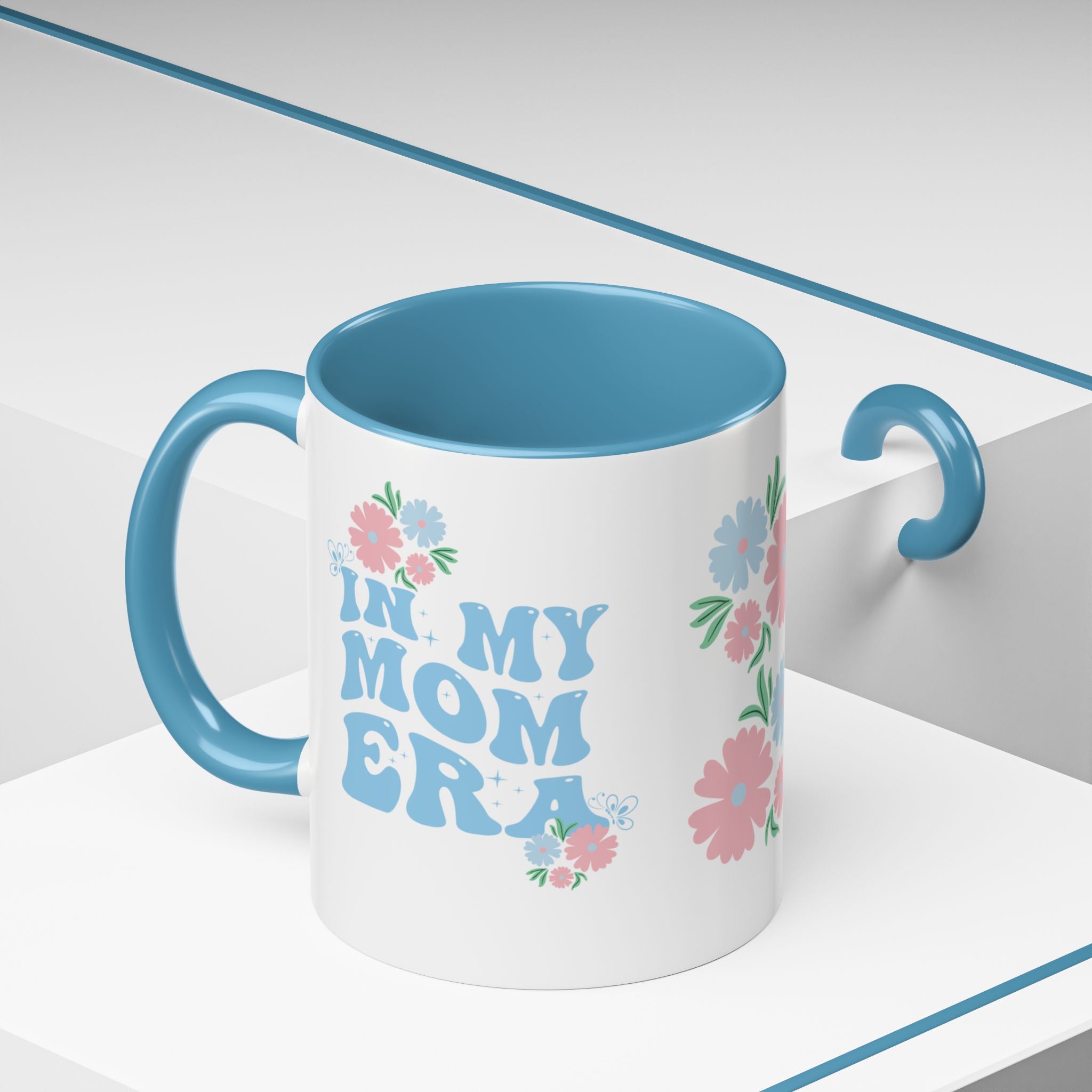 Mug with 'In My Mom Era' text and floral designs on a white background
