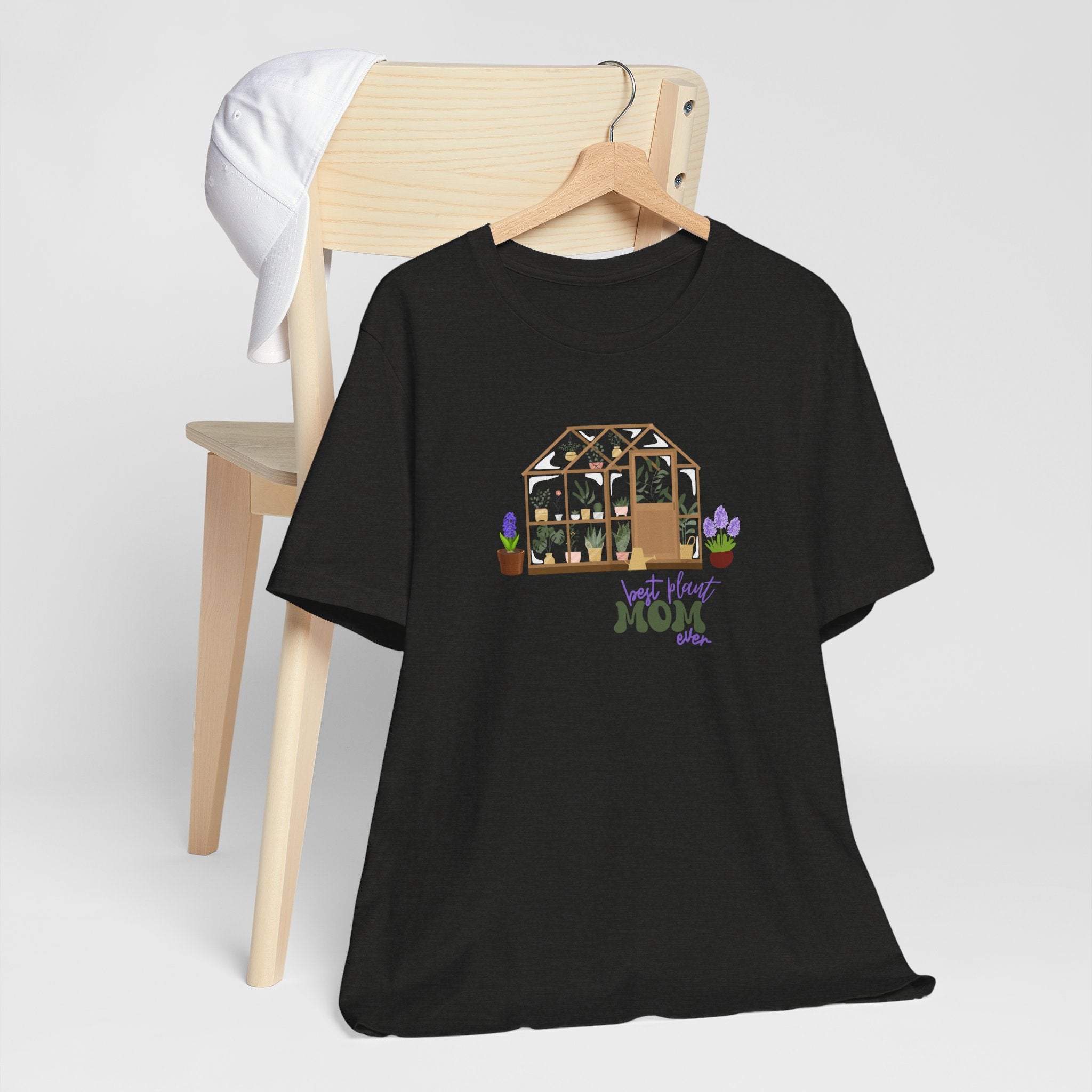 a black shirt with a greenhouse design and the words "best plant mom ever."  