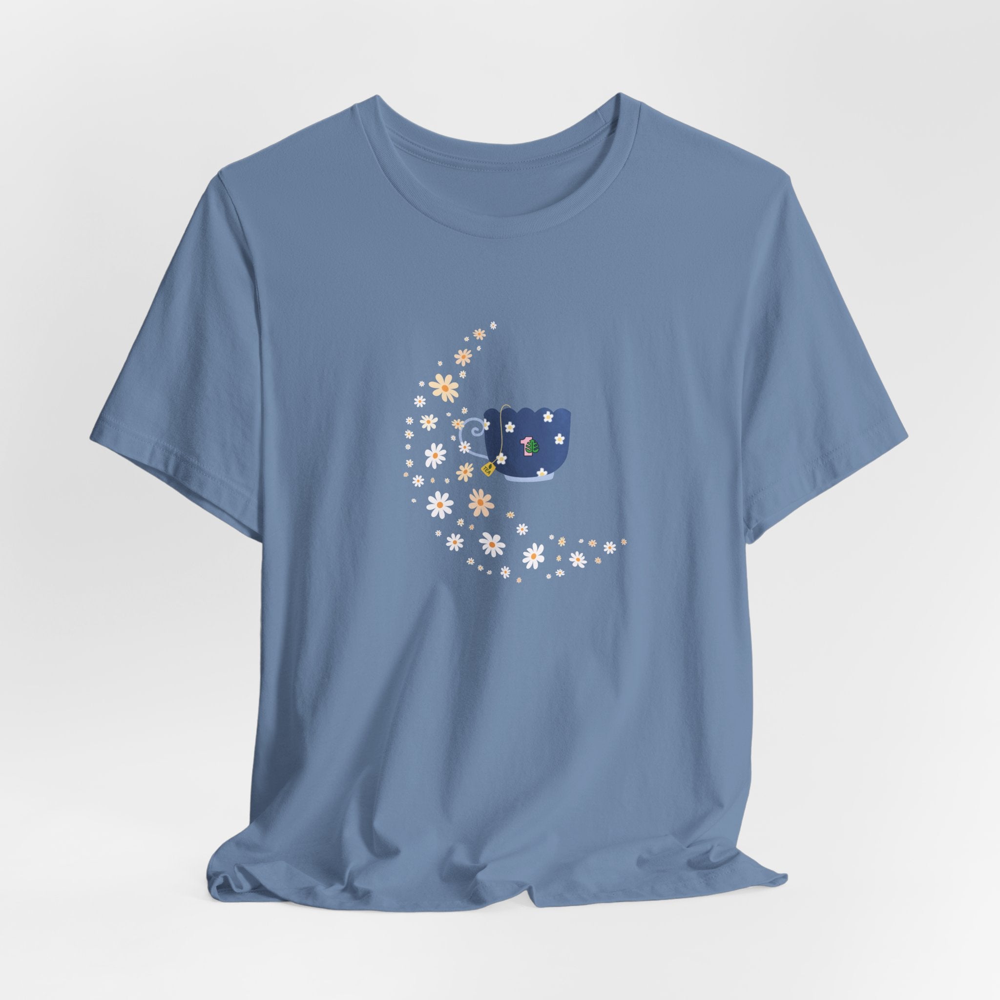 A steel blue colored tee-shirt featuring a floral moon and a teacup design.  It has a crew neck and short sleeves.  
