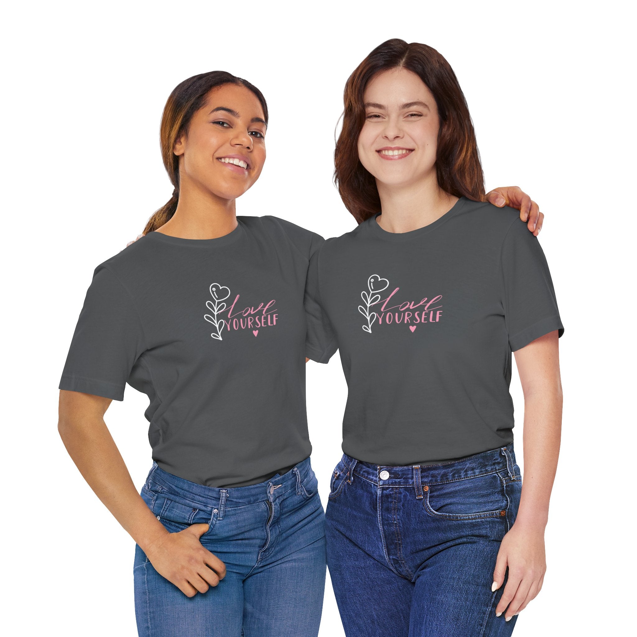 Picture of two young ladies wearing an asphalt colored shirt with pink text that says "love yourself".  