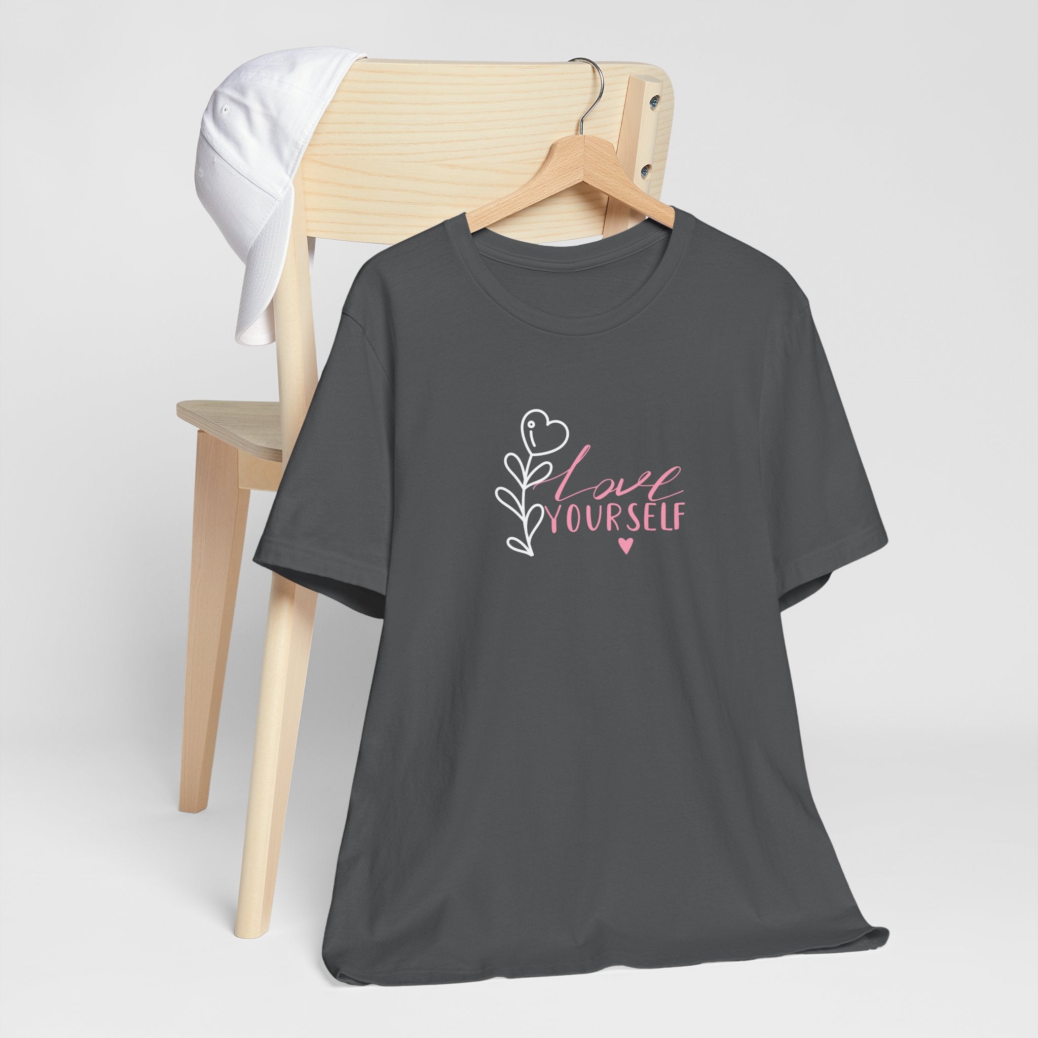 Picture of folded Asphalt colored top with pink text that says "love yourself".  
