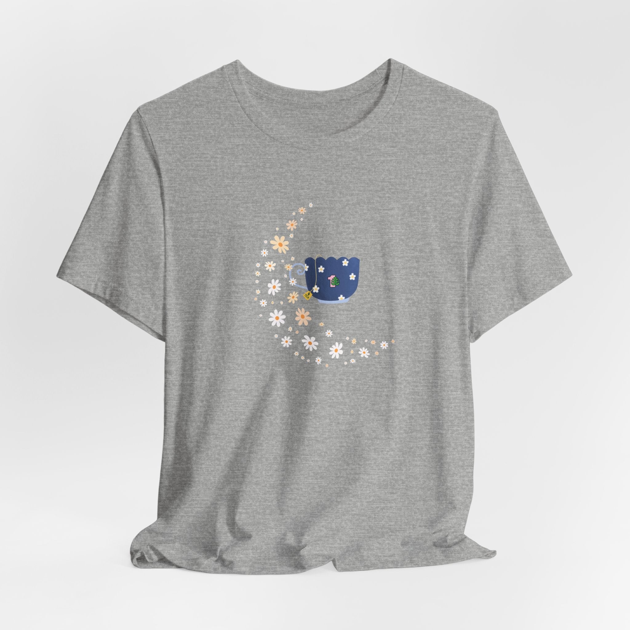 A tee-shirt featuring a floral moon and a teacup design.  It has a crew neck and short sleeves.  