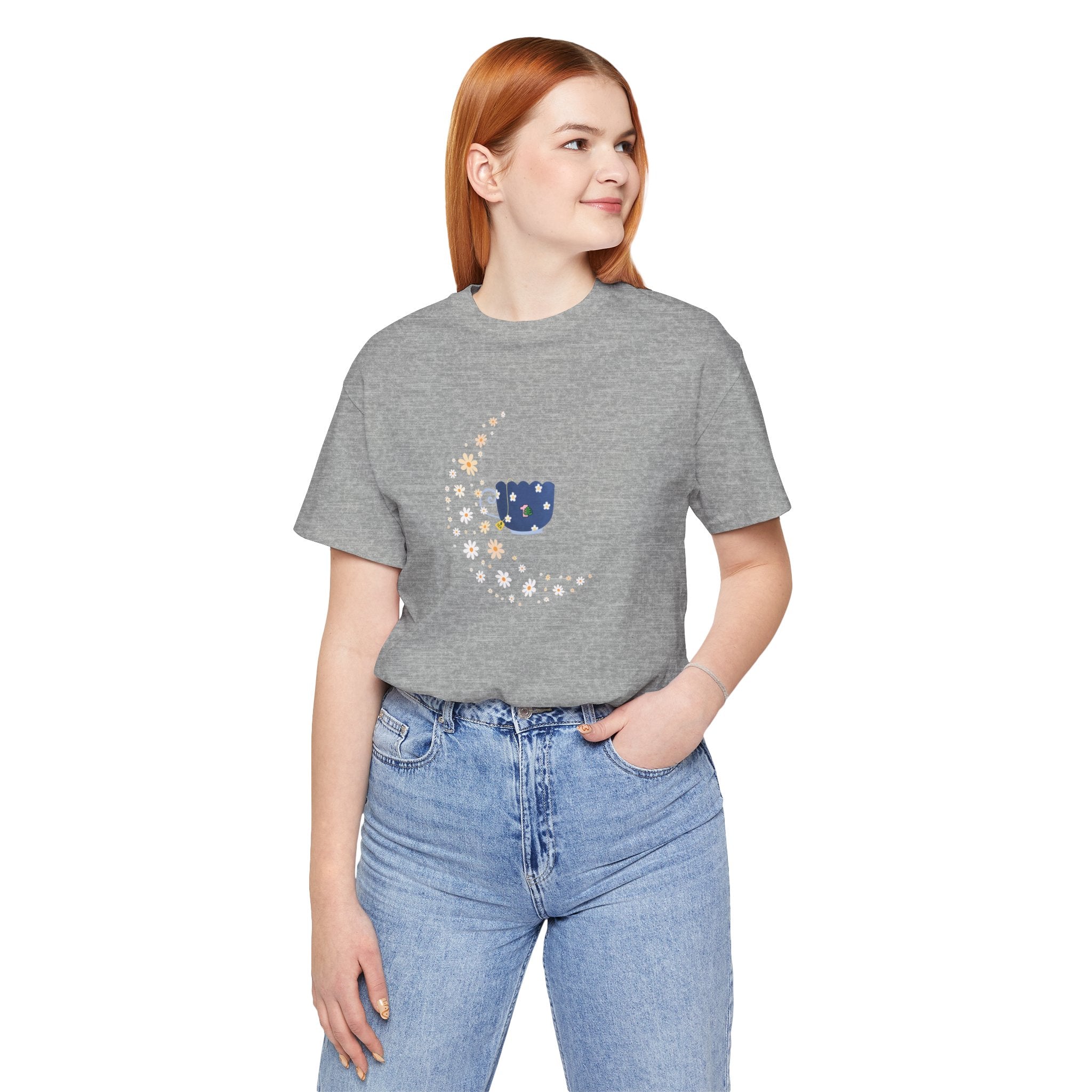 A tee-shirt featuring a floral moon and a teacup design.  It has a crew neck and short sleeves.  
