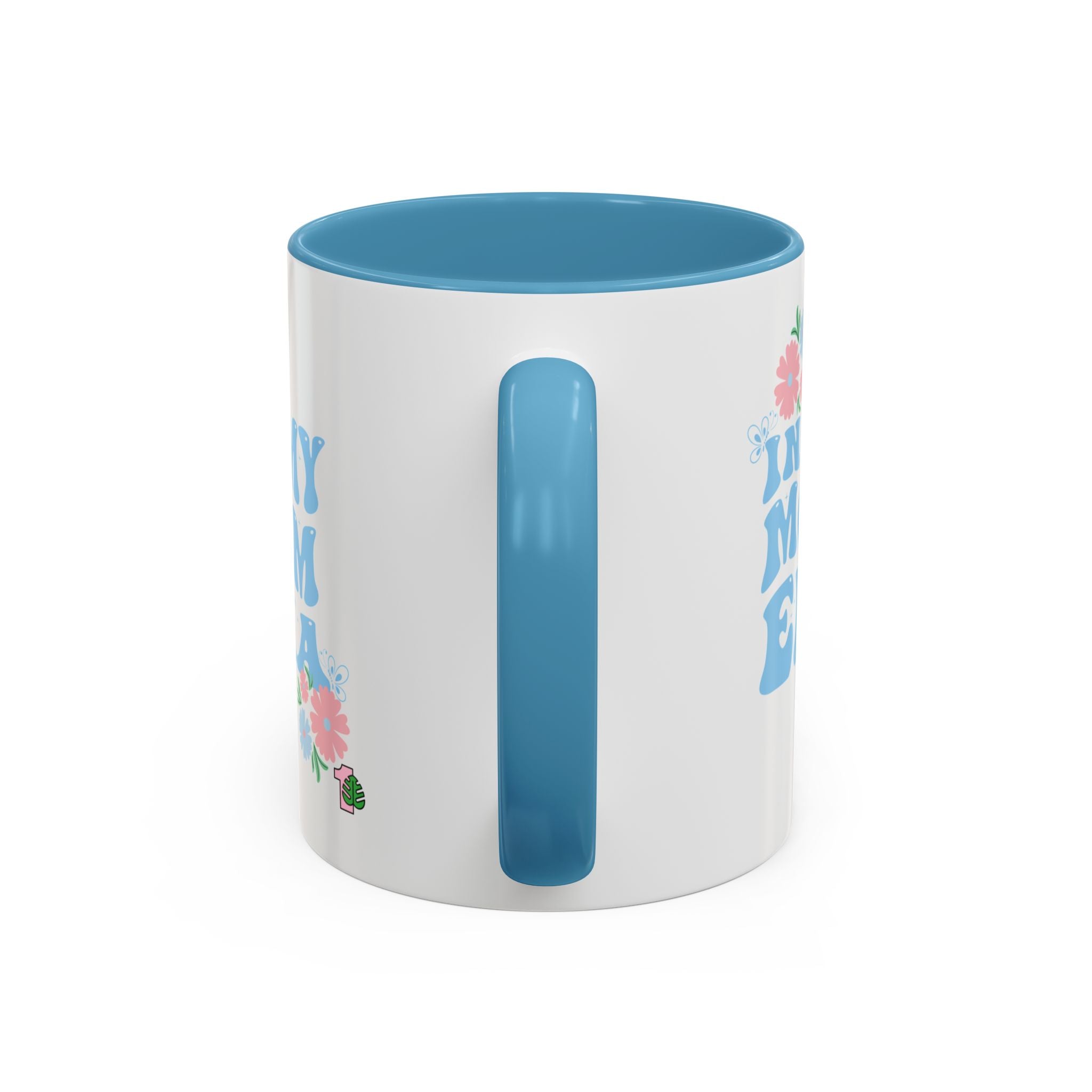 White mug with blue interior and handle, featuring floral designs and text on a white background