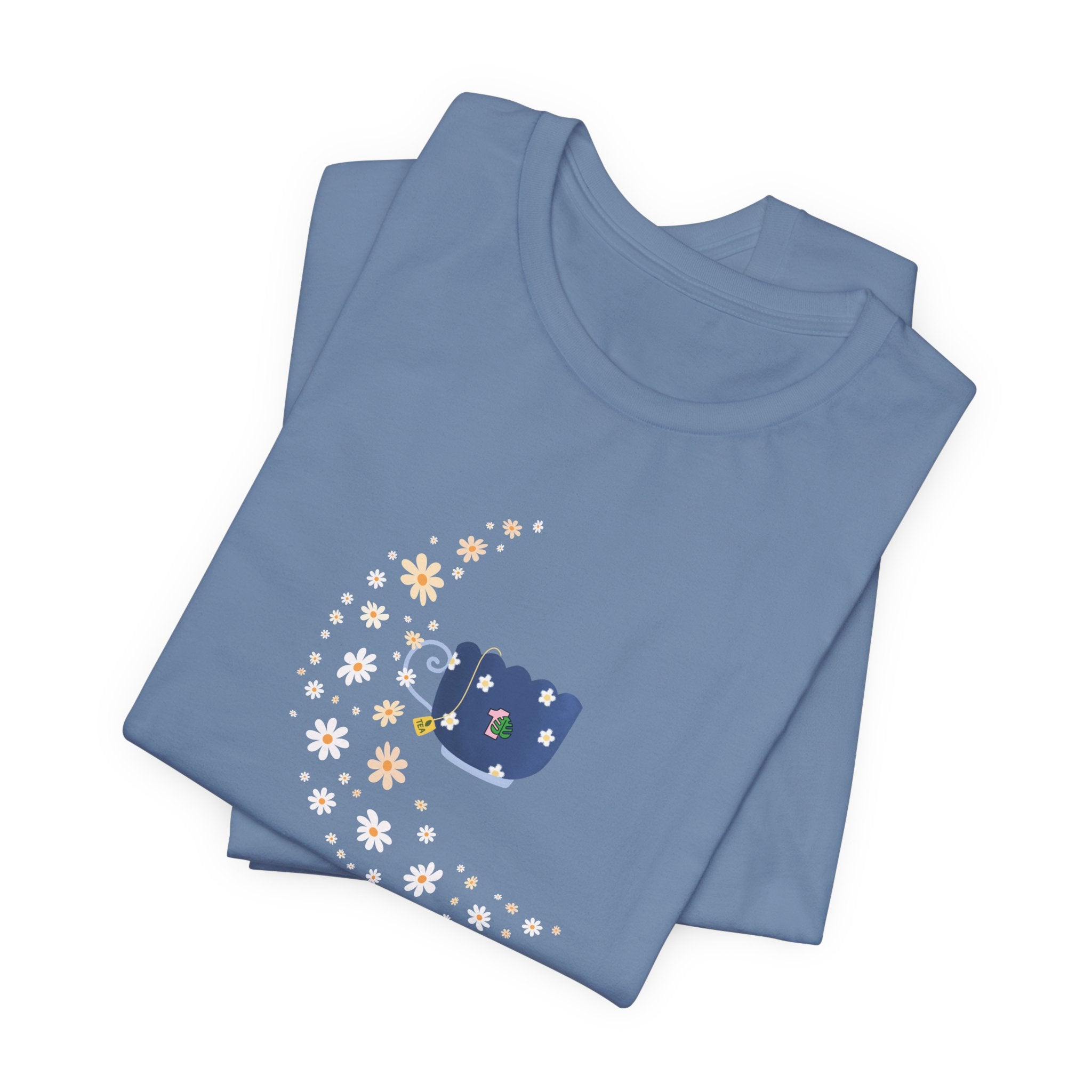 A soft t-shirt featuring a floral moon and a teacup design.  This folded shirt comes in a steel blue color.