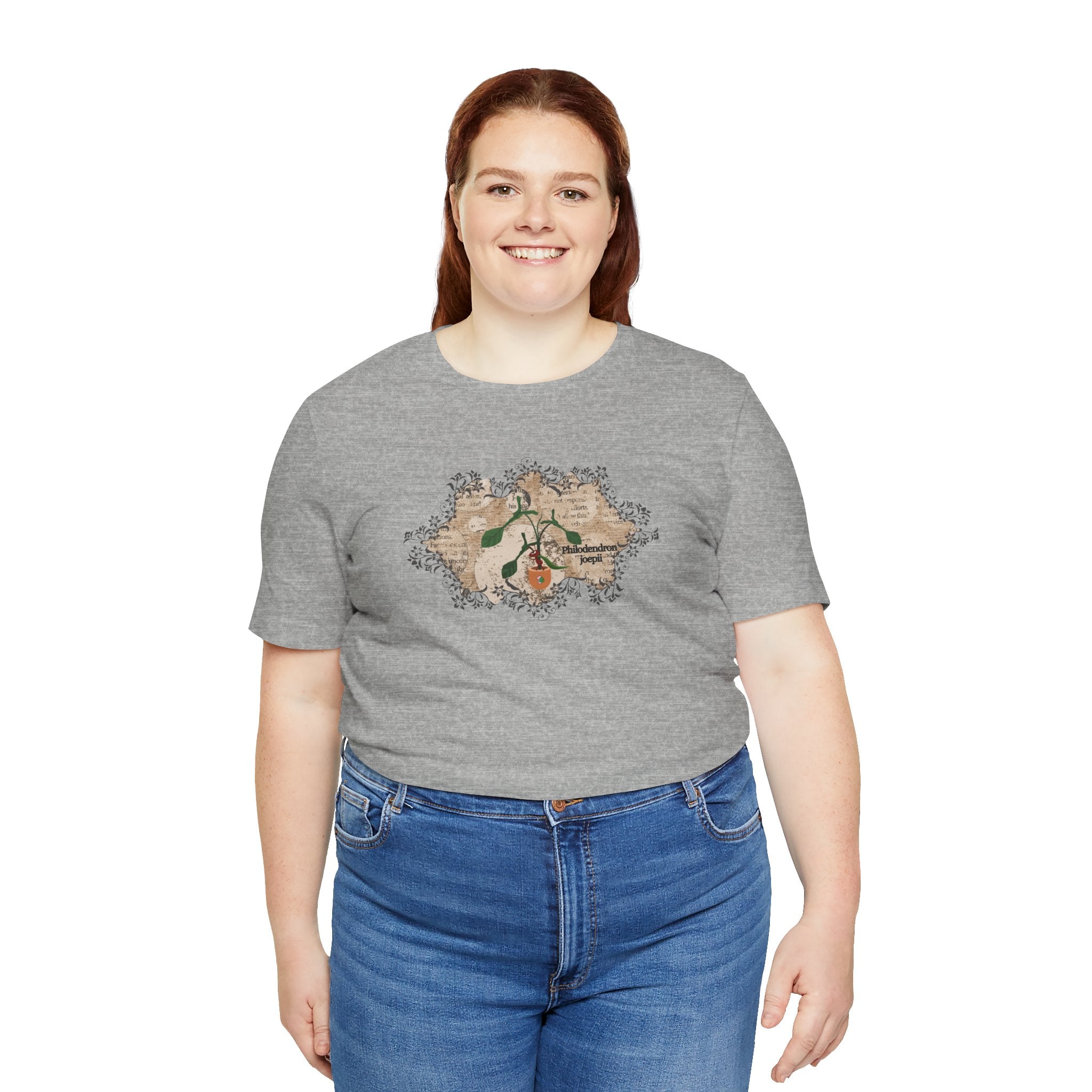 A tee shirt with a philodendron joepii plant design, an ant eating the plant, and the 1pink1 plants logo. Perfect plant shirt for a friend.