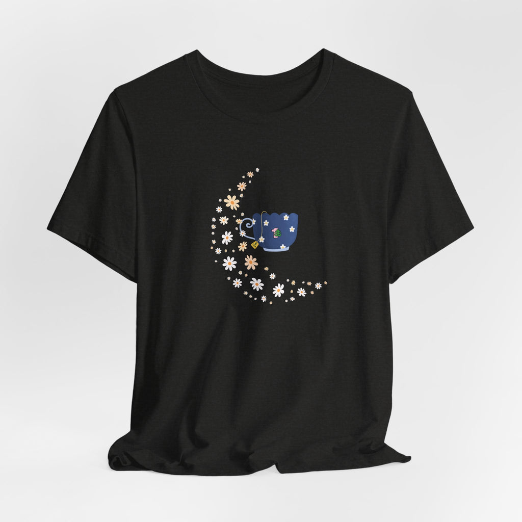 A whimsical floral moon and floral tea cup printed on a folded black colored shirt.