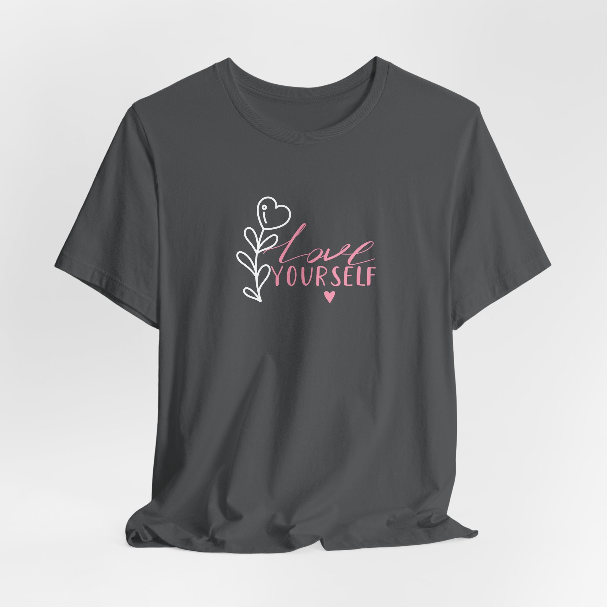 Picture of folded Asphalt colored shirt with pink text that says "love yourself".  